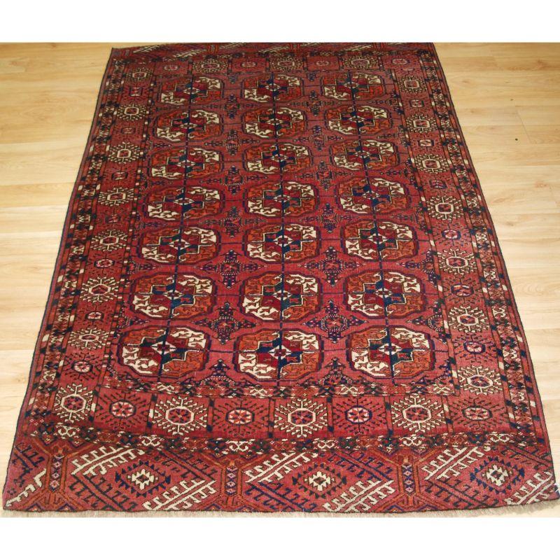 Antique Tekke Turkmen ‘dip khali’ rug of small size.

These are considered to be ‘half size’ rugs; half the length and half the width of a main carpet.

This example has 3 rows of 7 Tekke guls with deep crimson colour to the centers.

The rug