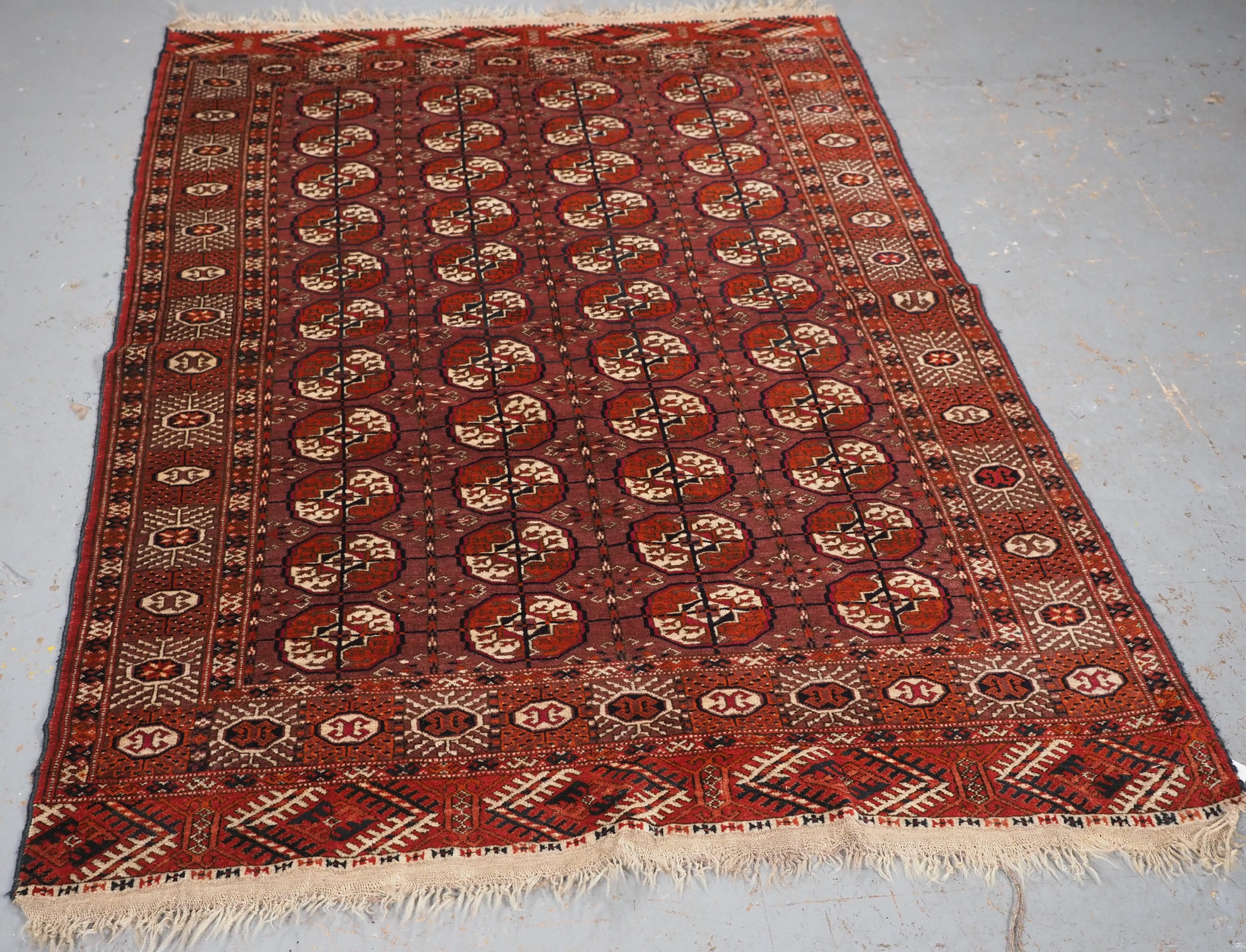 Size: 5ft 11in x 4ft 1in (180 x 125cm).

Antique Tekke Turkmen ‘dip khali’ rug with scarce aubergine ground colour.

Circa 1900.

These rugs are considered to be ‘half size’ rugs; half the length and half the width of a main carpet.

This excellent