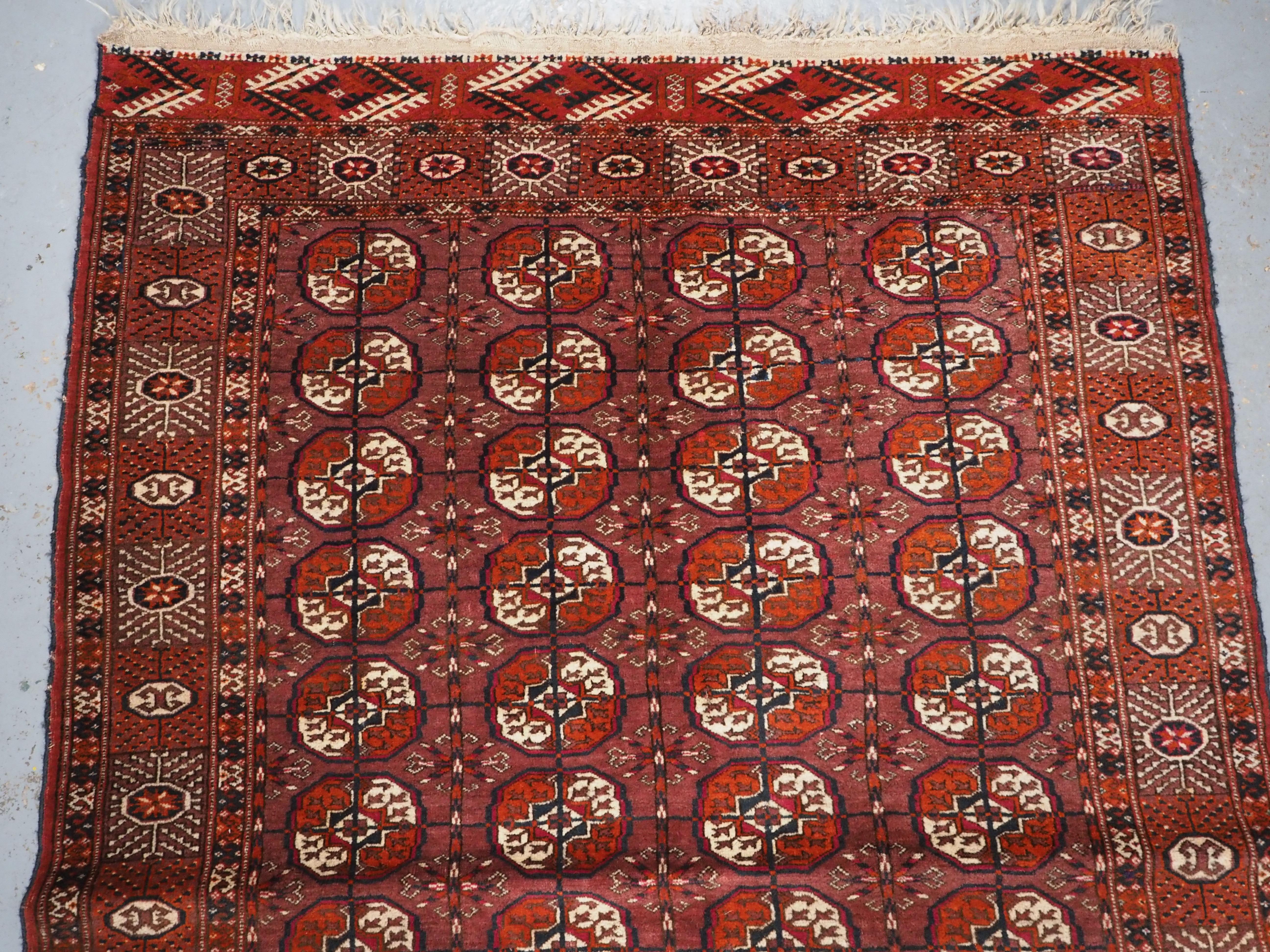 Caucasian Antique Tekke Turkmen ‘dip khali’ rug with scarce aubergine ground colour, 1900. For Sale