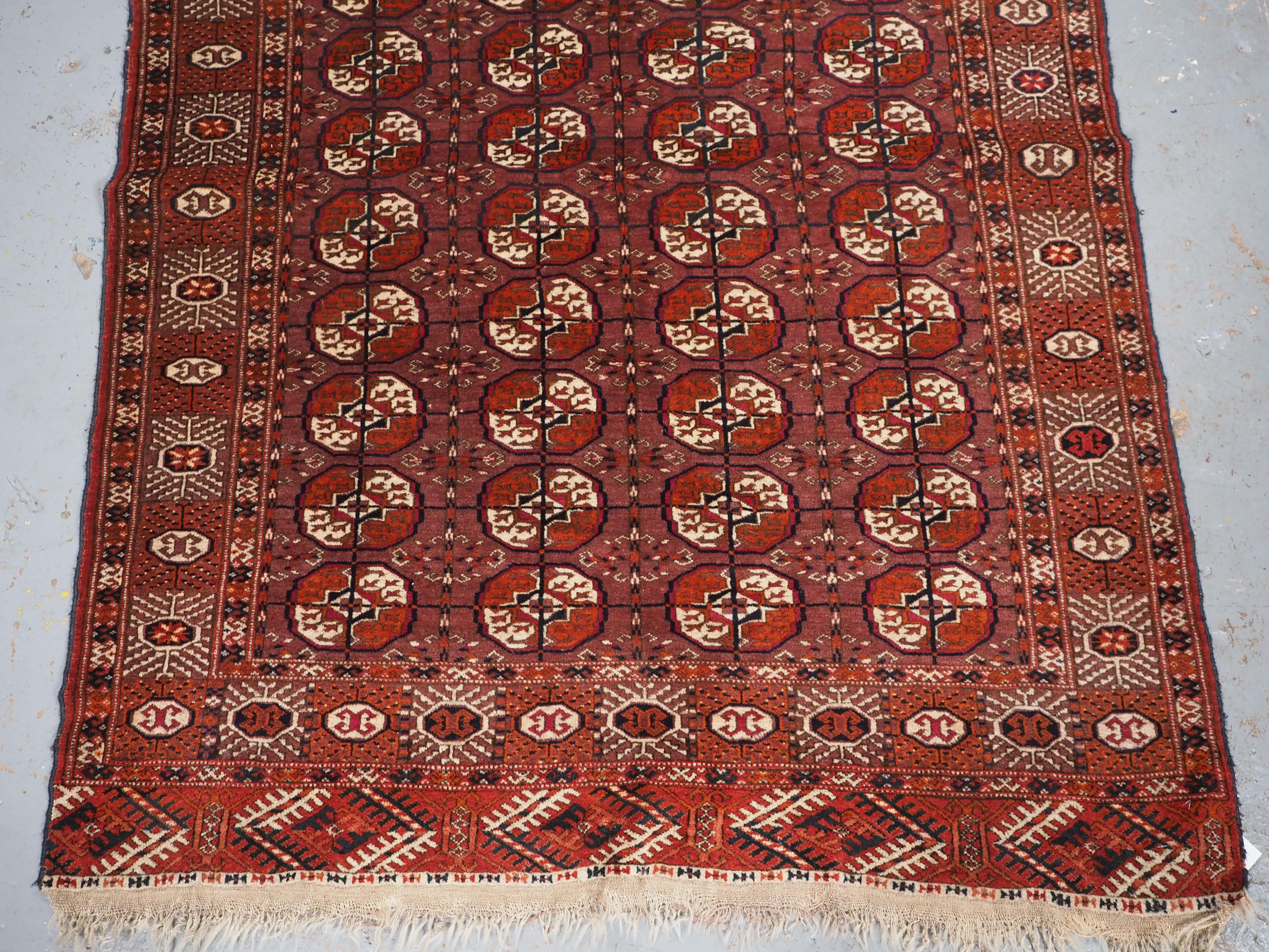 Early 20th Century Antique Tekke Turkmen ‘dip khali’ rug with scarce aubergine ground colour, 1900. For Sale