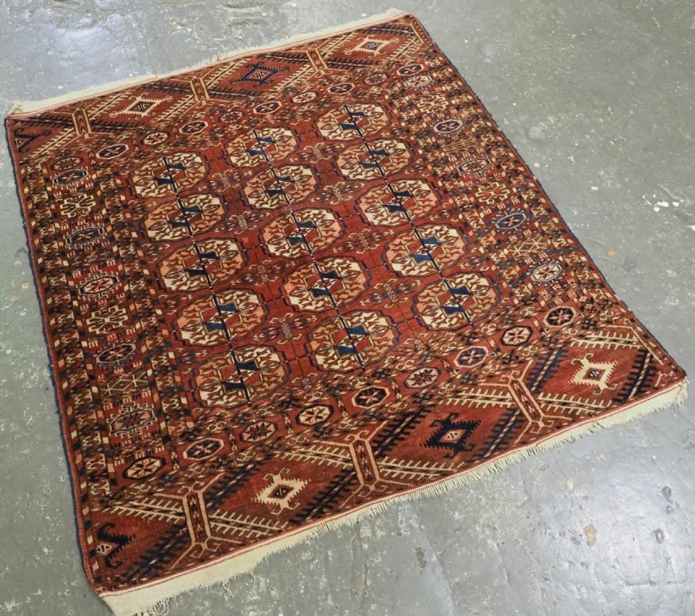 Antique Tekke Turkmen rug of fine weave and small square size
Circa 1880 or earlier

These rugs are considered to be ‘dowry’ weavings used by the Turkmen bride on her wedding day

This example has 3 rows of 5 large Tekke guls on a clear madder red,