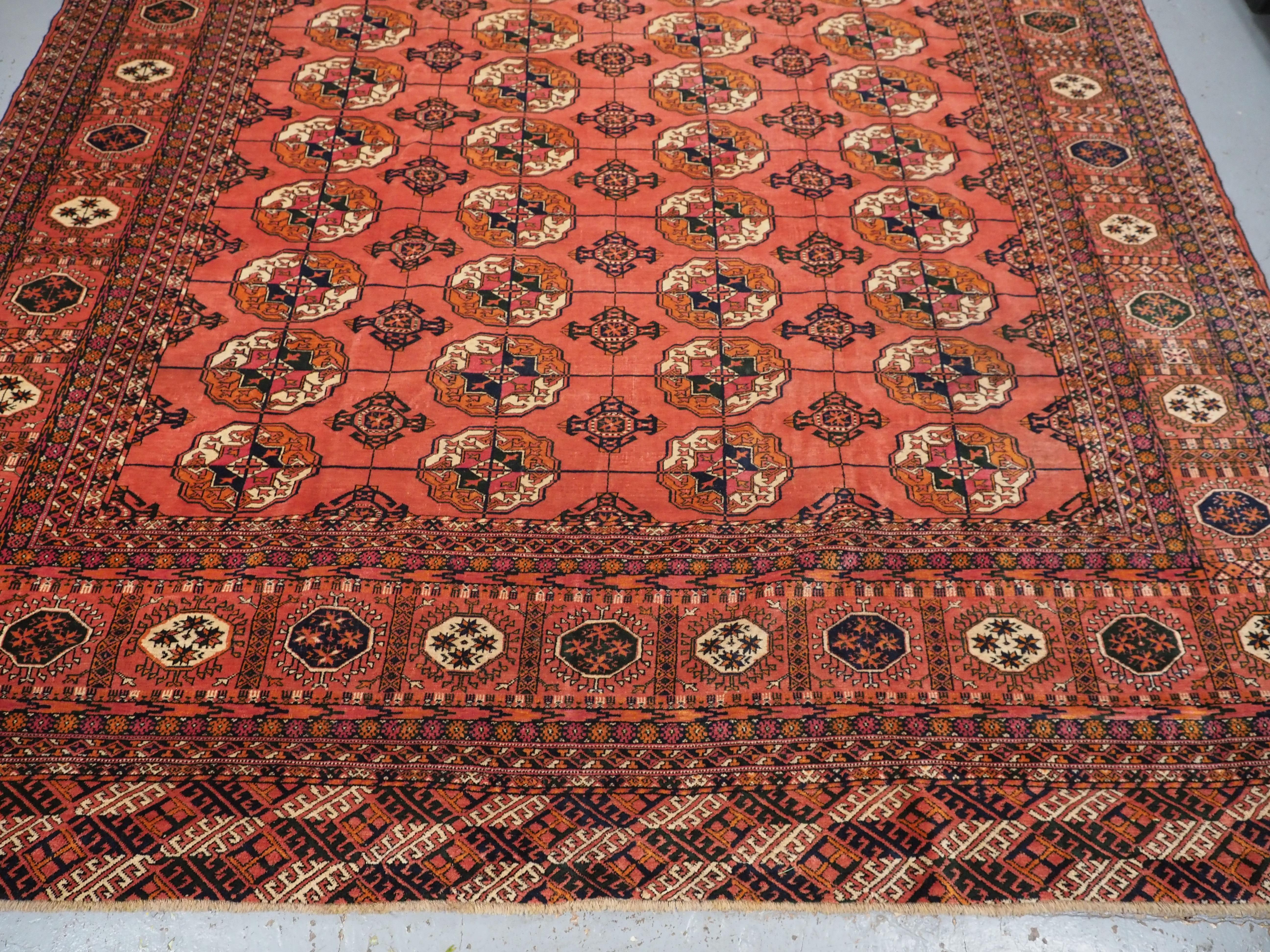 Early 20th Century Antique Tekke Turkmen main carpet with 4 rows of 12 guls.  Circa 1900. For Sale