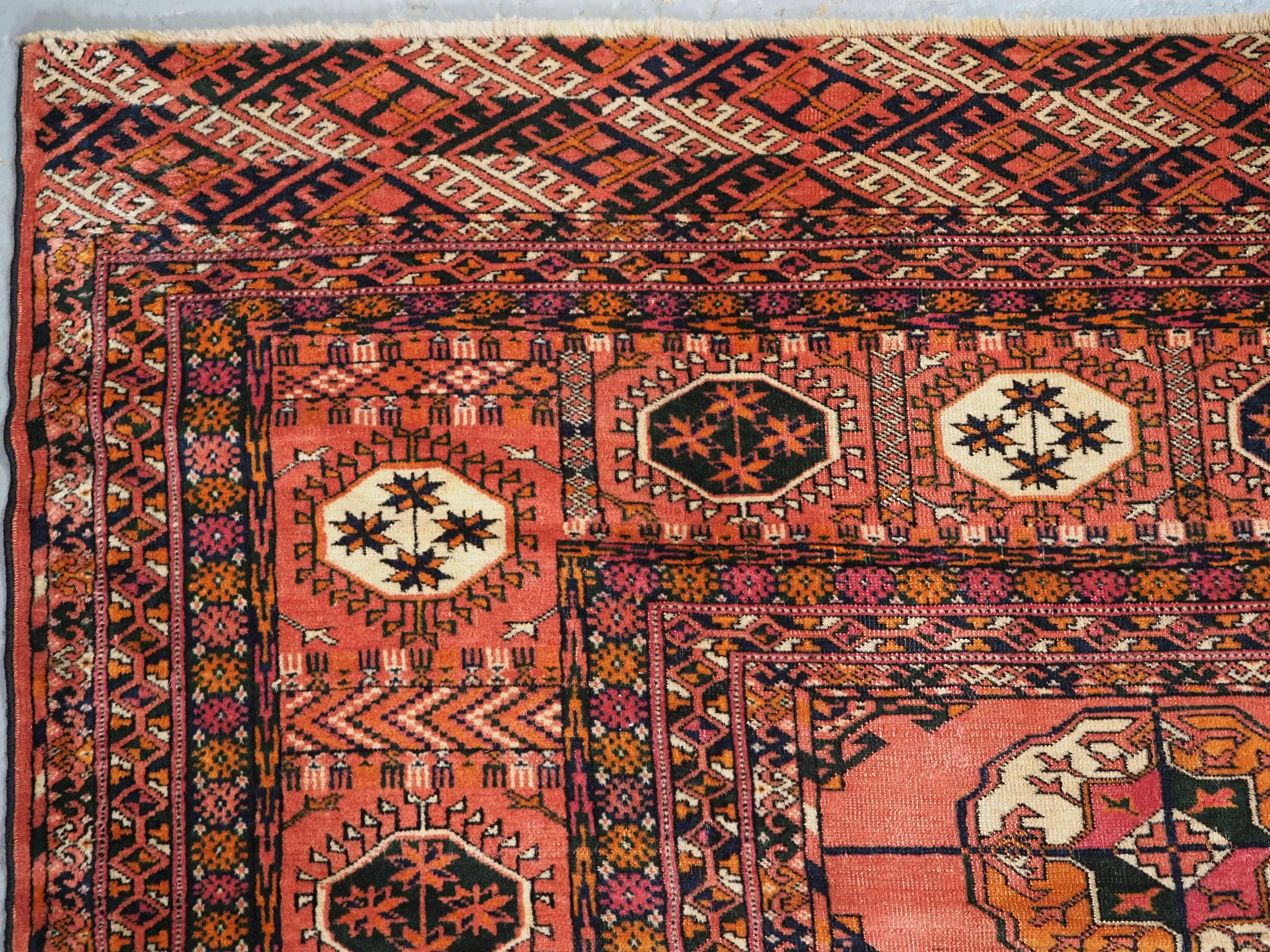 Wool Antique Tekke Turkmen main carpet with 4 rows of 12 guls.  Circa 1900. For Sale