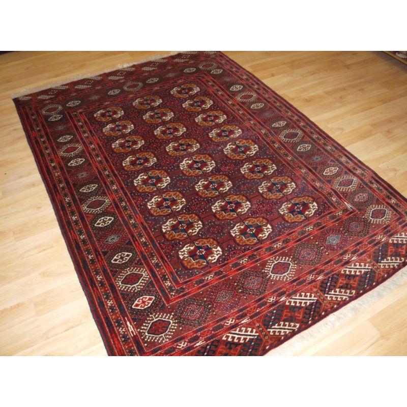 Antique Tekke Turkmen rug of traditional design and excellent colour, the rug is of a rich red colour with orange tones.

The rug has a traditional Tekke gul design with 3 rows of 8 guls.

The rug is of a fine weave with excellent soft