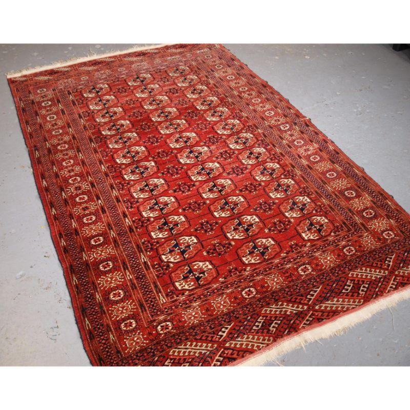 Antique Tekke Turkmen rug of traditional design and excellent colour, the rug is of a soft red colour.

The rug has a traditional Tekke gul design with 3 rows of 12 guls. The border is the sun burst design, both ends retain the original kilim