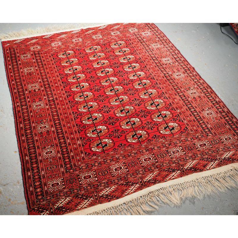 Antique Tekke Turkmen rug of traditional design and excellent colour, the rug is of a soft red colour.

The rug has a traditional Tekke gul design with 3 rows of 10 guls, the border is of the sunburst design. Note the original ivory kilim end