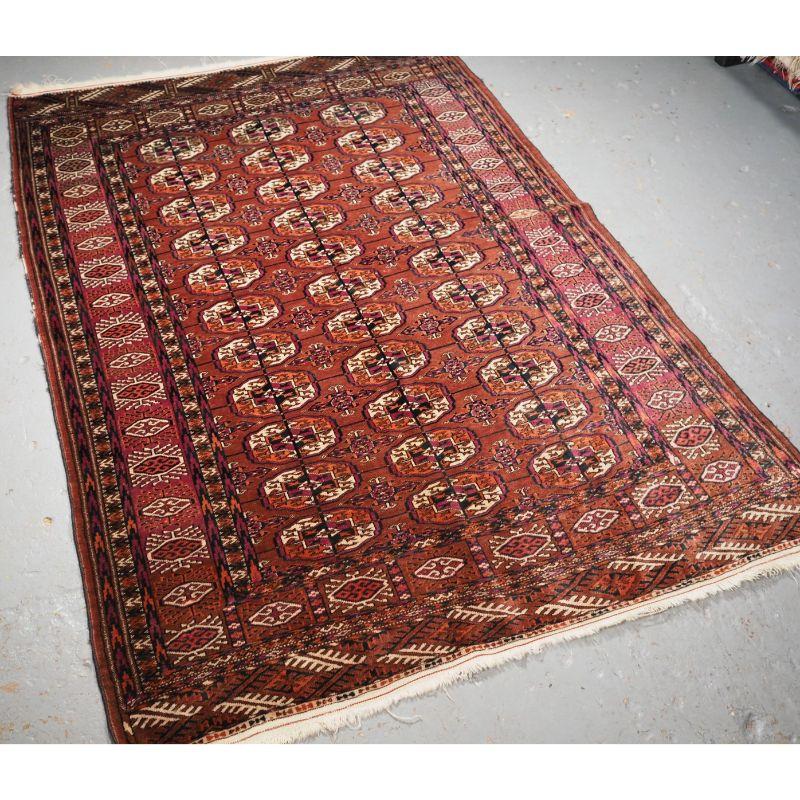 Antique Tekke Turkmen rug of traditional design and pleasing colour.

The rug has a traditional Tekke gul design with 3 rows of 11 guls. The rug has a soft warm colour with cochineal dye used extensively in the border.

The rug is of a fine weave