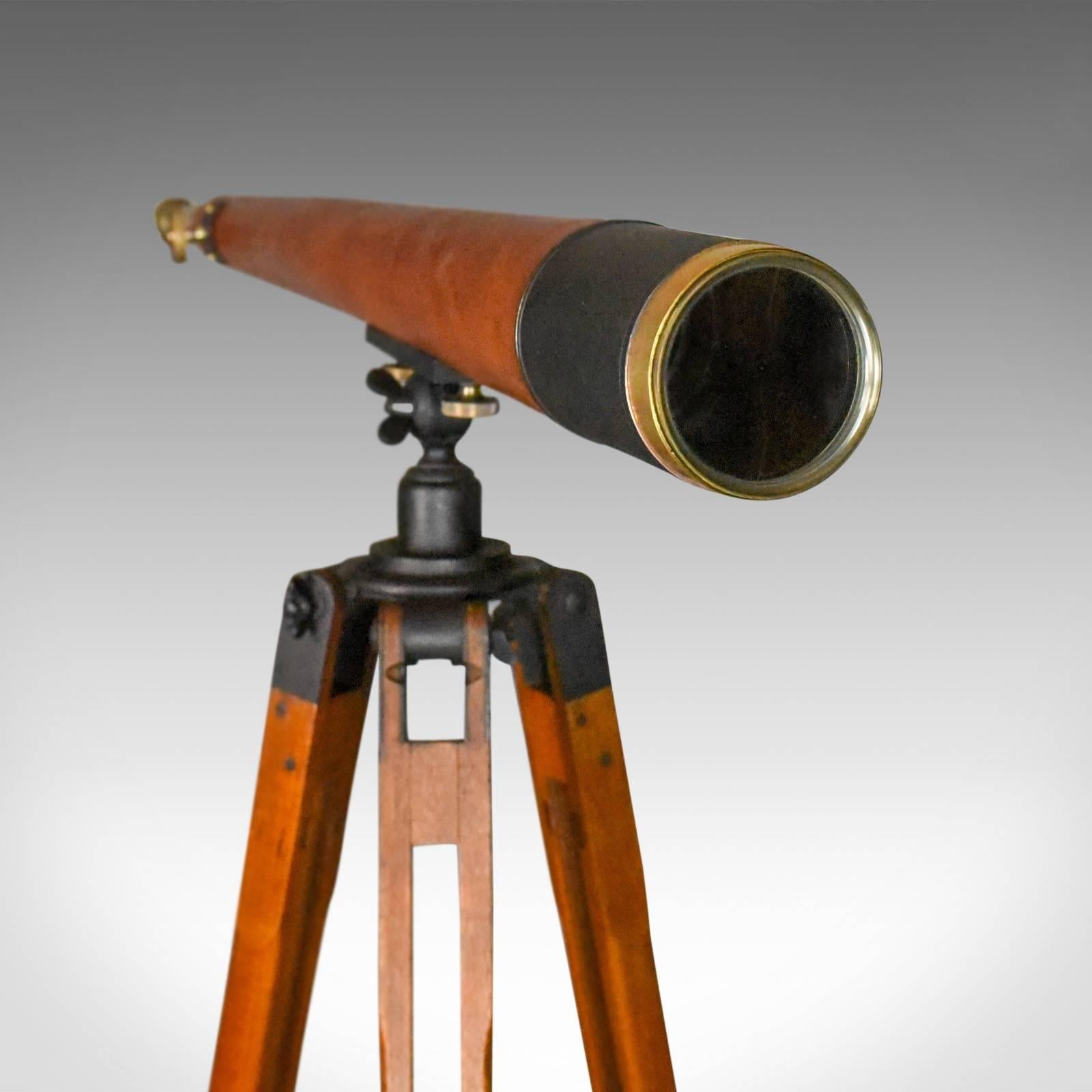 This is an antique telescope on tripod, a three inch tapered refractor for terrestrial or astronomical use, probably originally for military use and dating to circa 1900-1915.

Raised on an oak tripod with anti-glare, stealth paint mount, this