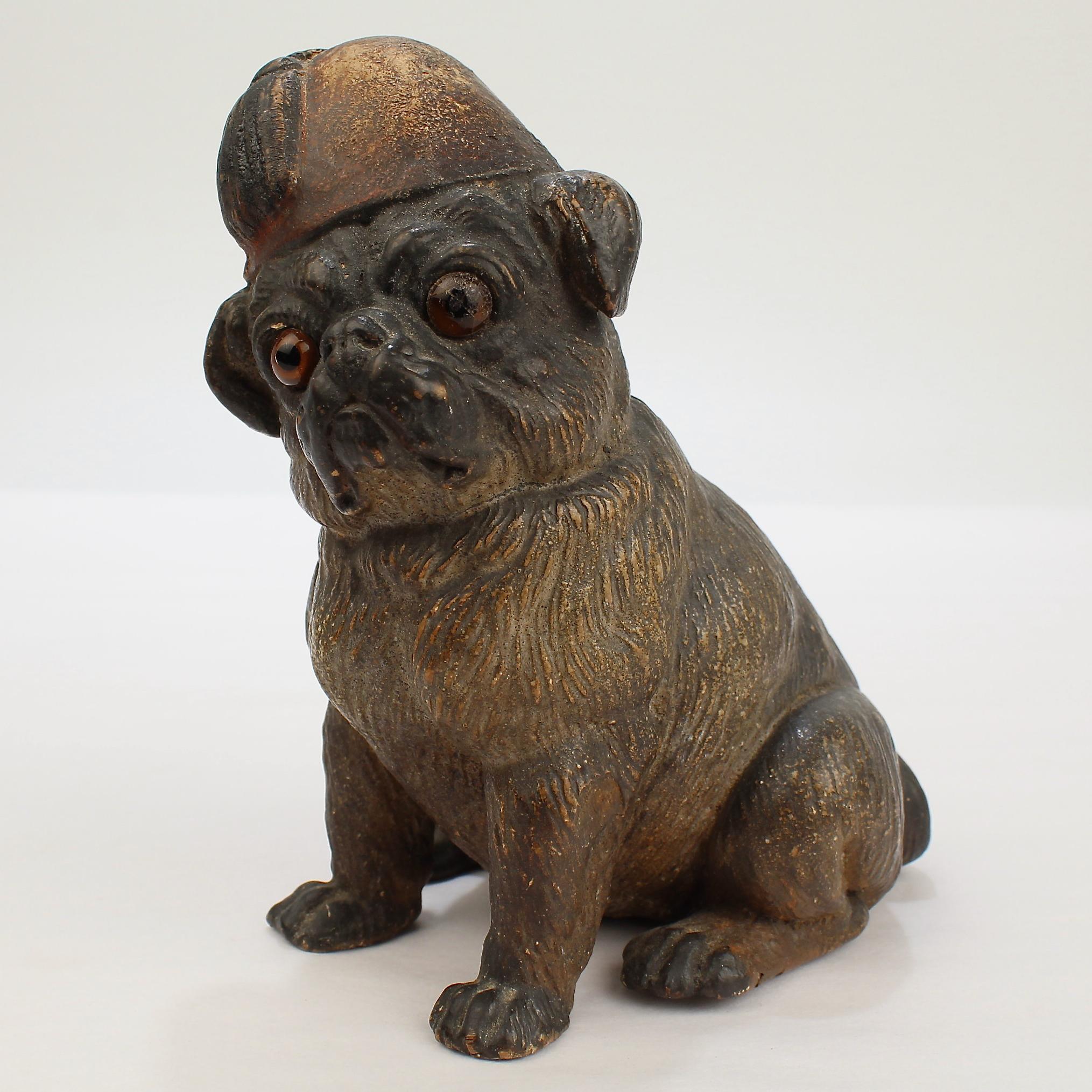 A very fine antique Austrian terra cotta dog figurine.

Depicted with its head slightly cocked to one side and wearing a Fez hat.

From the collection of Mario Buatta.

A stylish figurine directly from the collection of the legendary interior