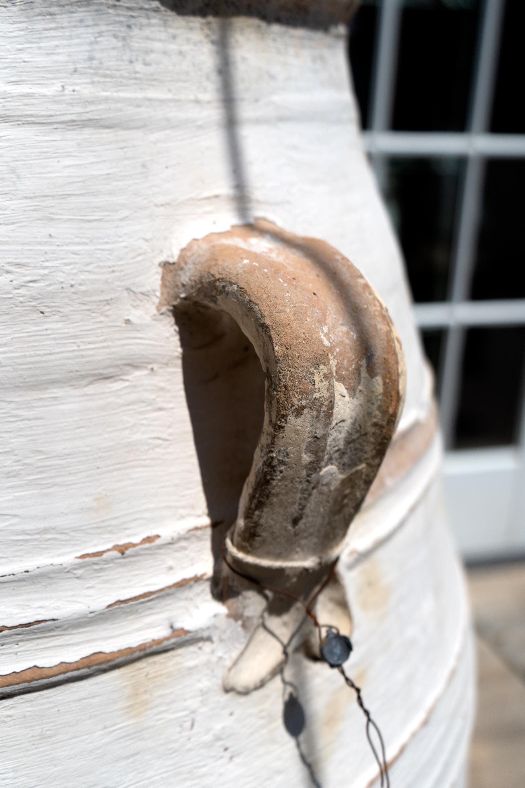 Large terracotta urn with white finish and gentle shape. I find these scattered across the elegant exteriors of homes in Southern France and Italy. The graceful silhouette and chalky white finish will add character to any interior or exterior of