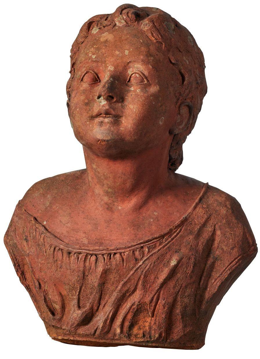 Antique terracotta bust of a Cherub. A Victorian terracotta bust modelled as a cherub. The young child features drapery around the top and shows signs of weathering. The bust was previously fitted with wings, which have been removed. Please see the