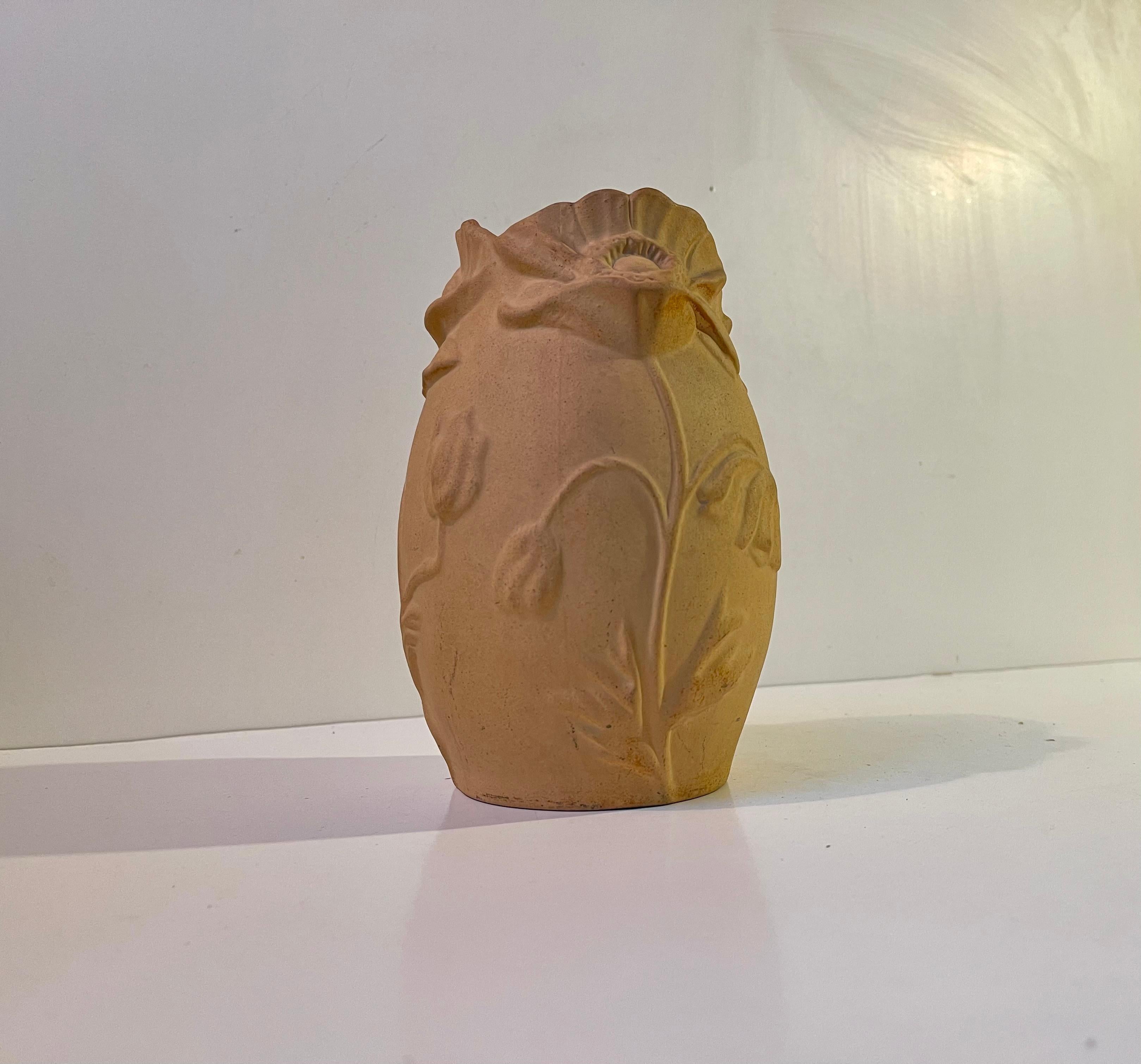 A jugend/art nouveau vase from Søholm number 112 dating back to the 1920s. It is executed in unglazed terracotta with relief flowers highlighting its organic and vivid shape. Very soft, delicate and tactile to the eye. The inside is glazed allowing