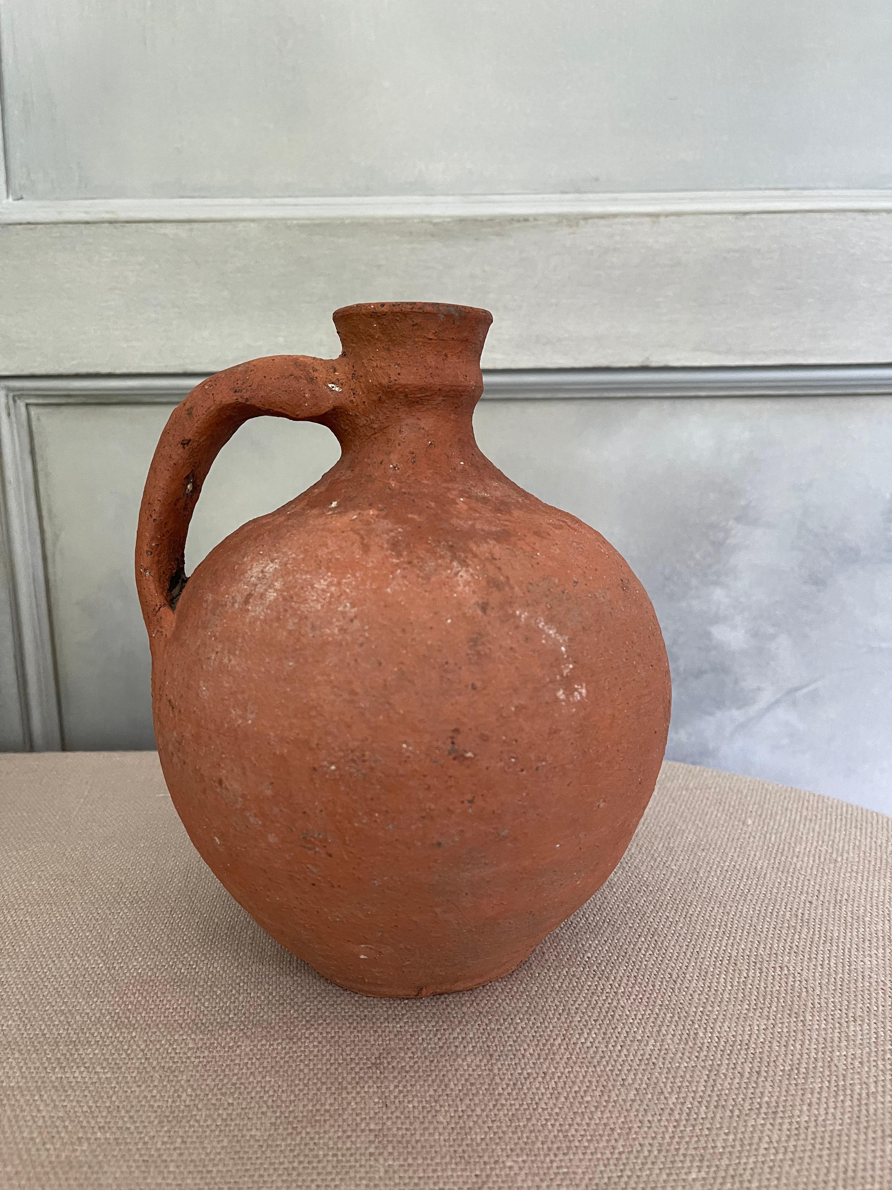 Antique terracotta clay vessel with handle. circa 19th century.