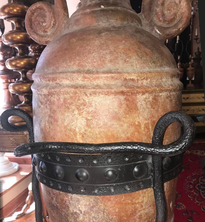 A 19th century French wine jar with forged iron base. Base in the shape of snakes, hammered finish.
Measurements:
Height 52