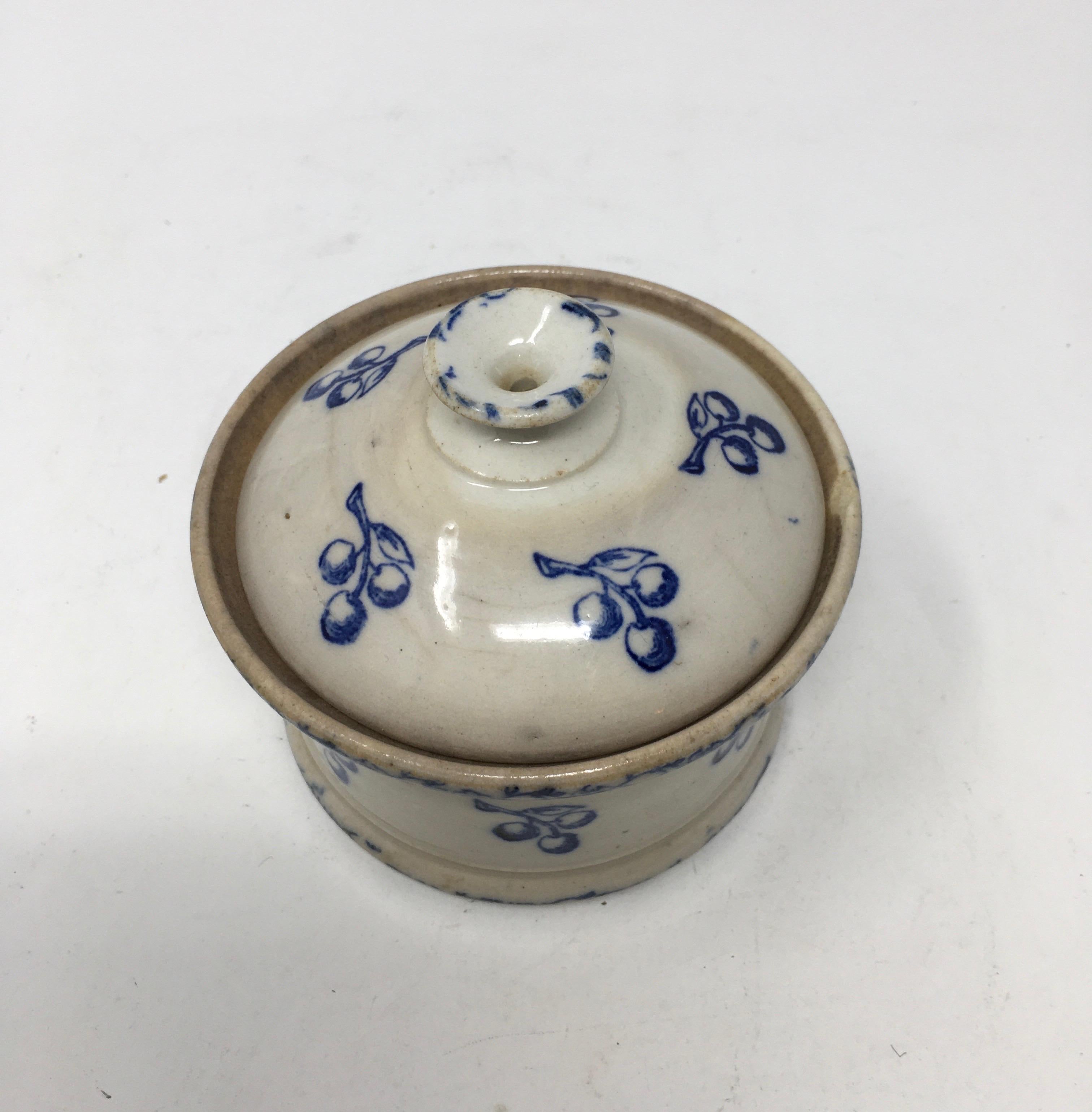 Found in France, this antique Ironstone Terre de Fonte lidded cache pot has lovely blue floral transferred design. The piece is complete with a knobbed pull handle on the lid and two handles on the cache pot itself. Signed Terre de Font St. Vallier