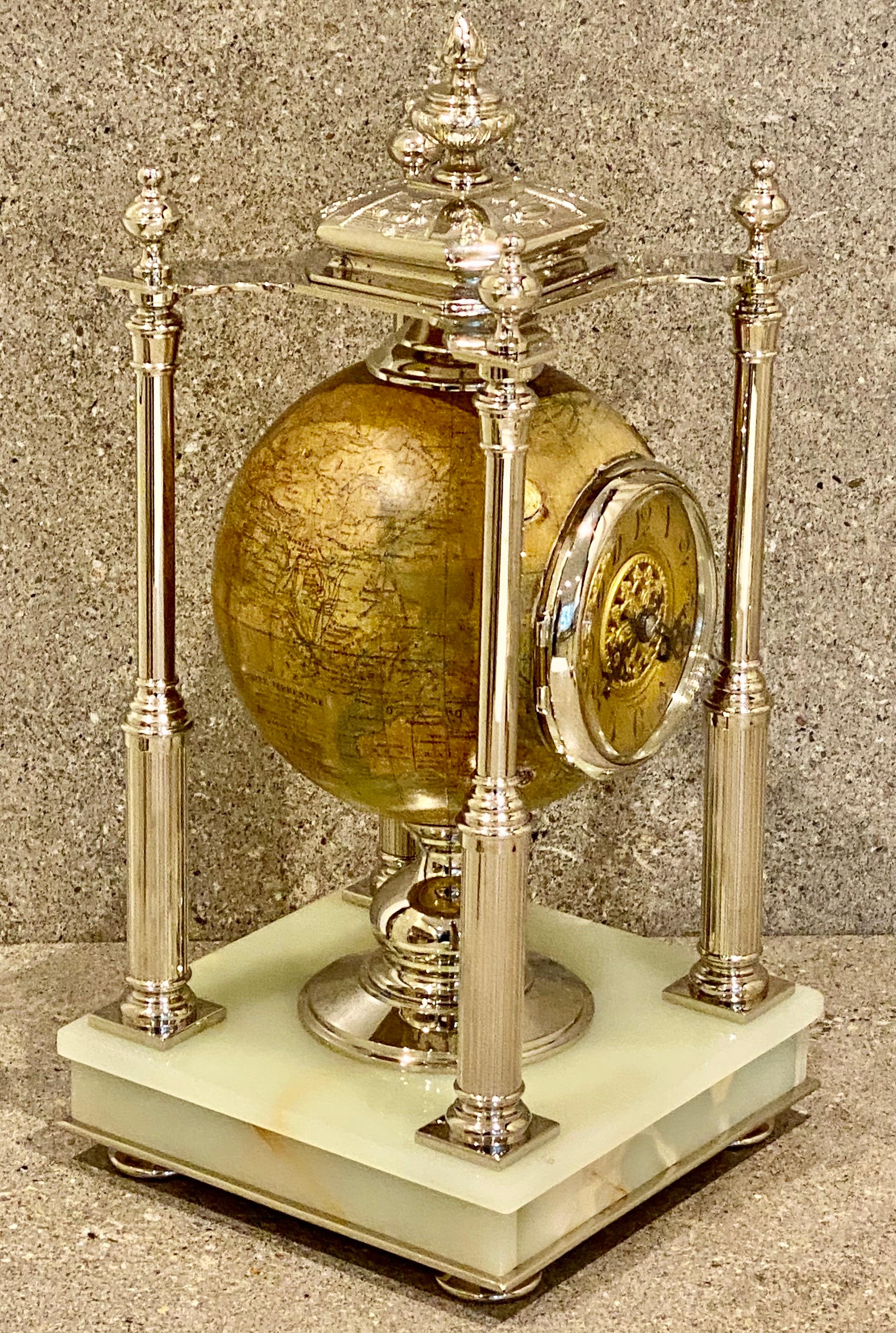 A rare French silver plated brass and pale onyx eight day striking globe clock by Ancely & Cie Toulouse. Circa 1890 The paper-lined terrestrial globe is signed Ikelmer, This superb clock set has a gilt chapter ring and a twin barrelled movement with