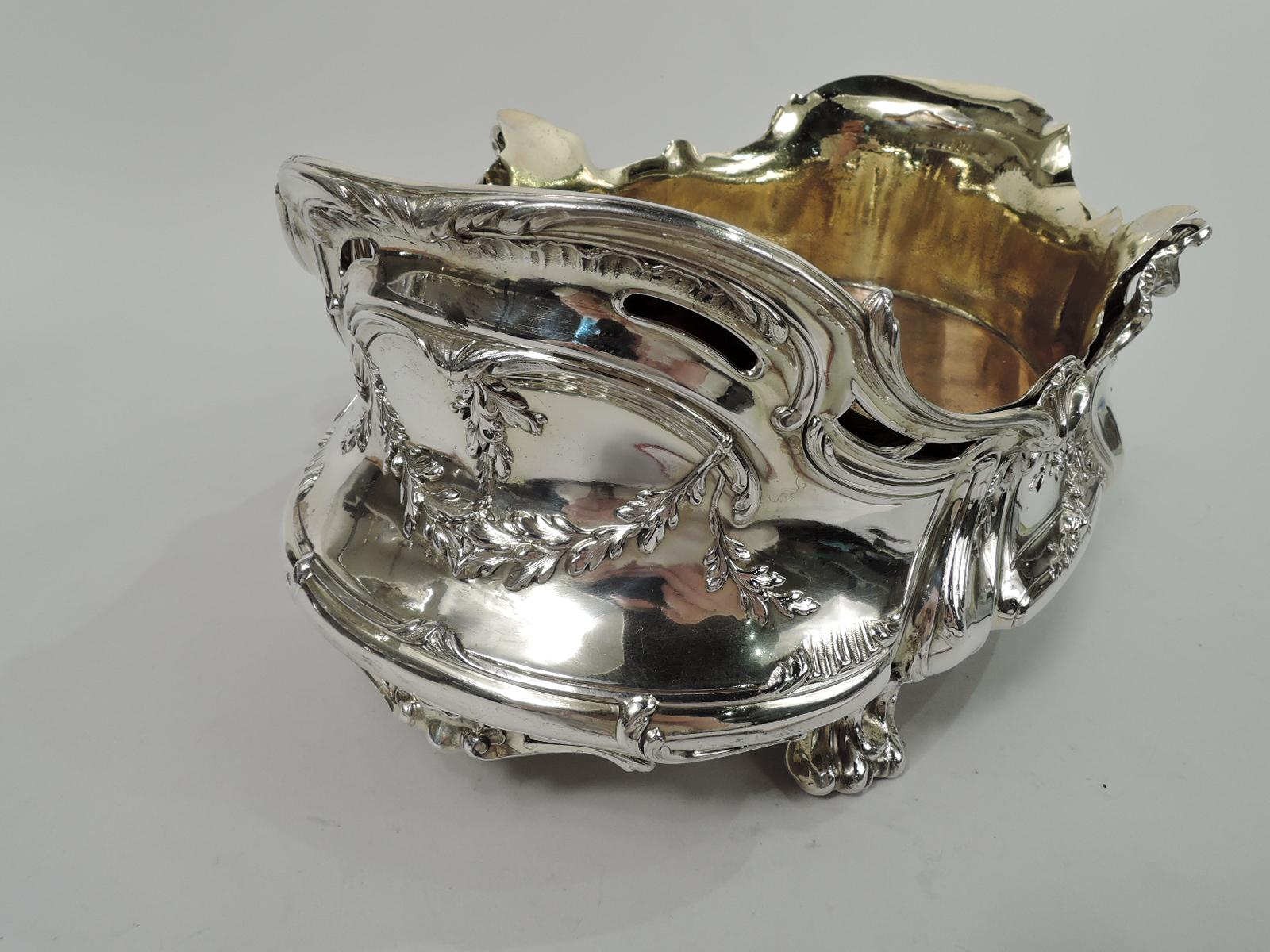 Belle Epoque Rococo 950 silver jardiniere. Made by Edmond Tetard in France, and imported to Scotland in 1898 by Edward & Sons in Glasgow. Oval and bellied with asymmetrical and open rim. Chased flowers, leaves, and shells, and leaf-bordered