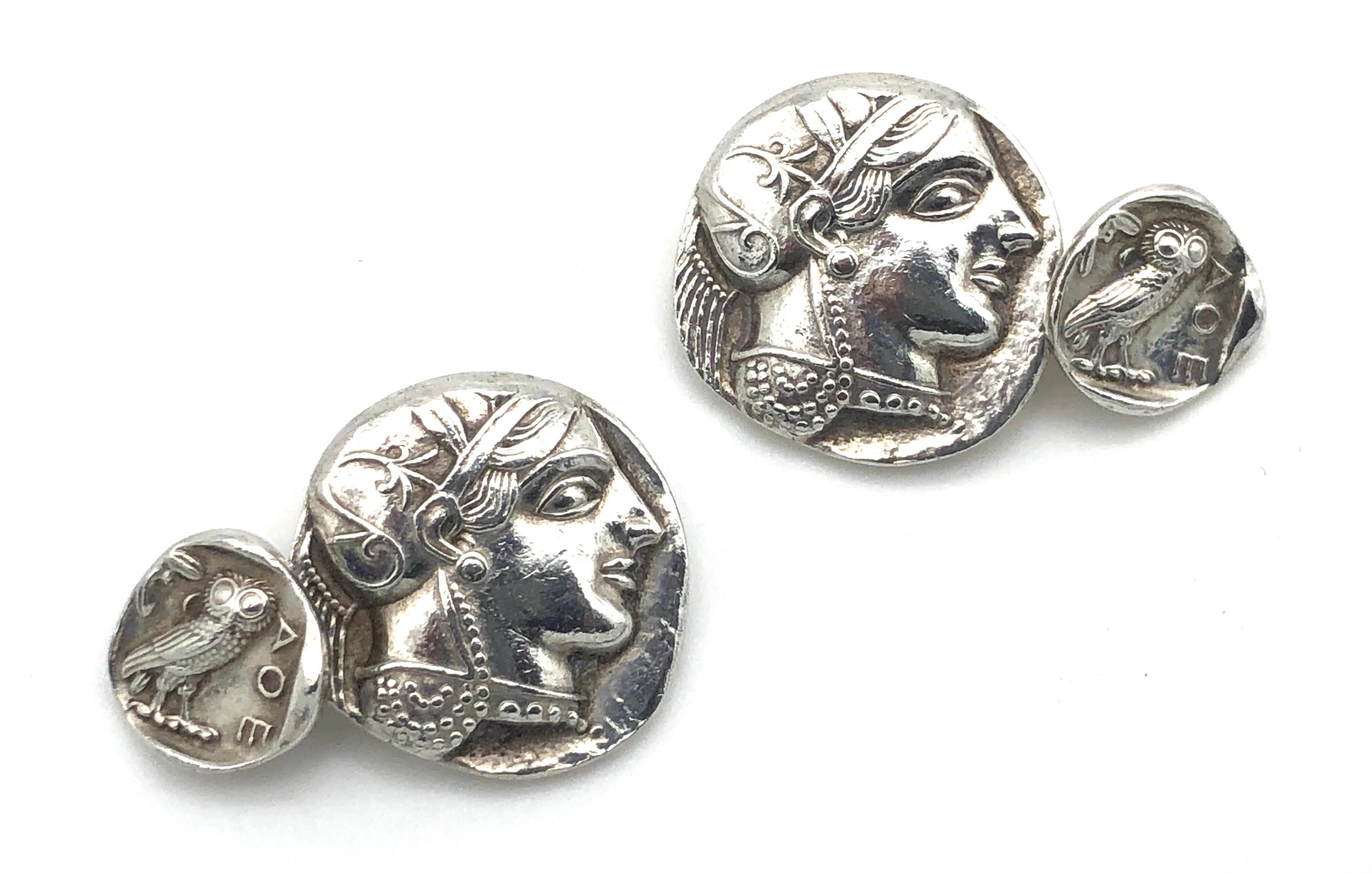 Solid silver casts of antique athenian tetradrachms have been made into an unusual pair of silver cufflinks. The front piece is a cast of the coin in original size depicting Athena, the greek goddess of wisdom and war. The smaller coin is a reduced