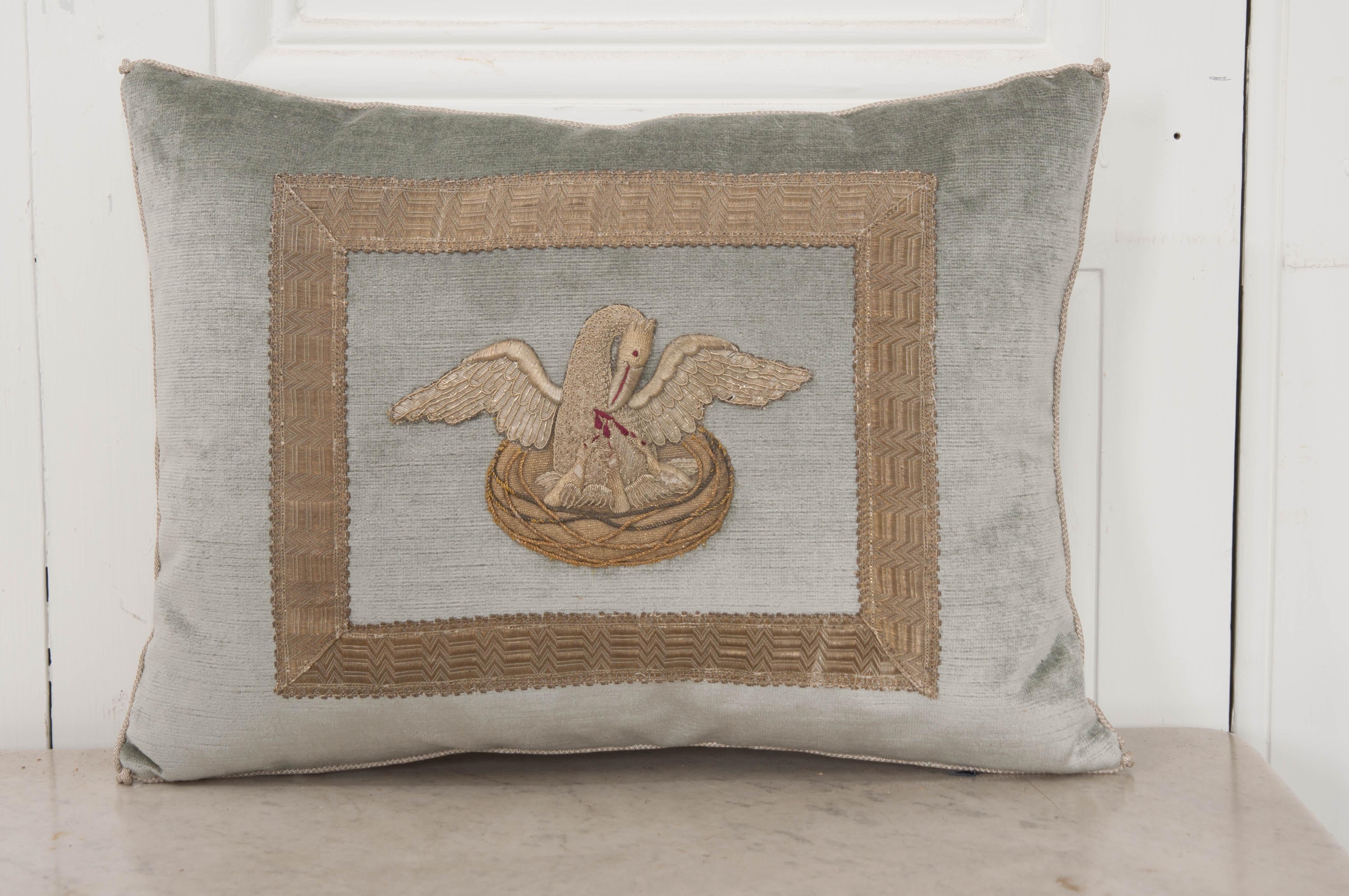 Antique Ecclesiastic silver embroidered Pelican in Her Piety appliqué framed with antique silver metallic gallon on pale French blue velvet. Hand trimmed with vintage silver metallic cording knotted in the corners. Down filled.