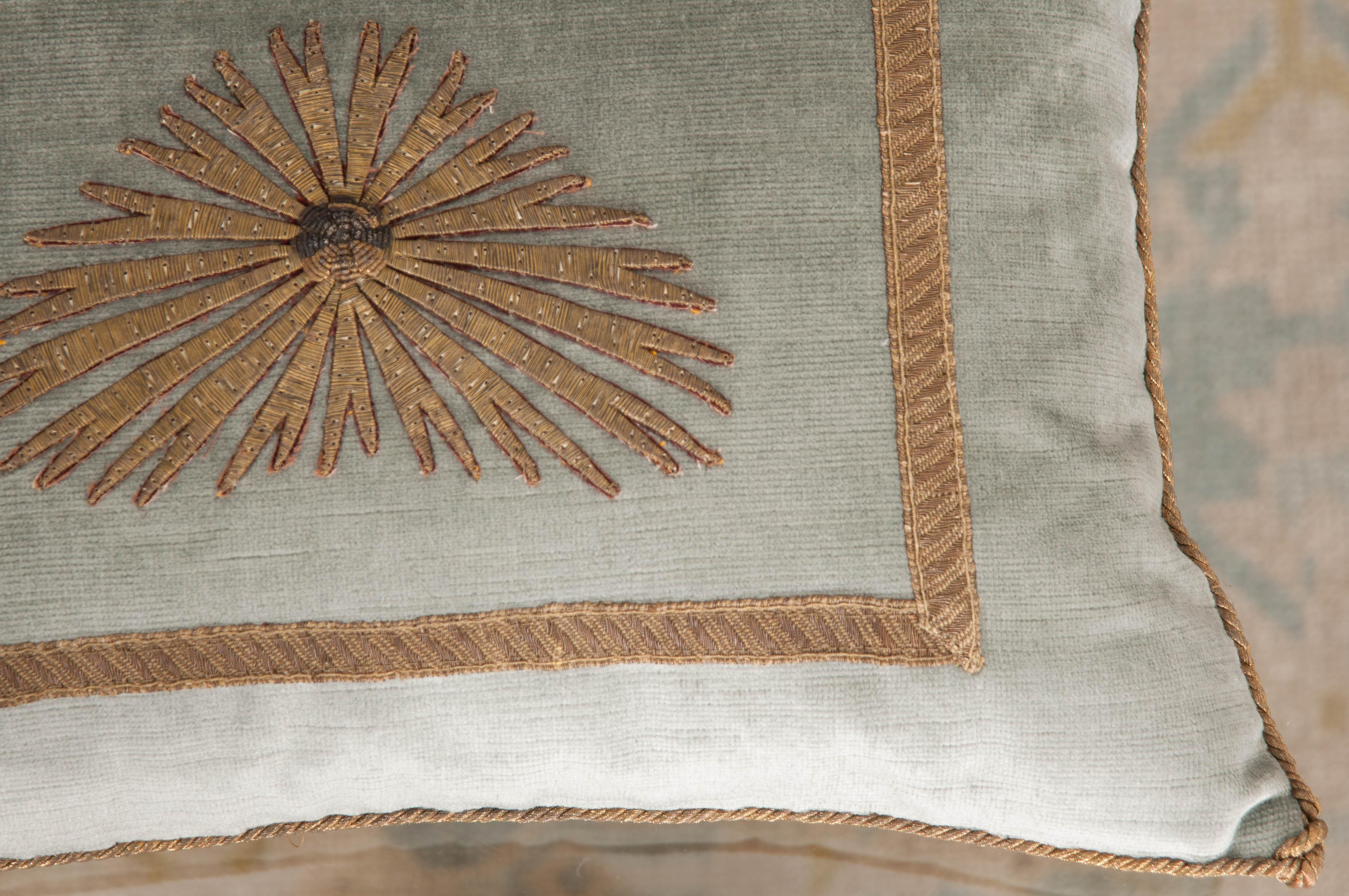 Antique ottoman Empire raised gold metallic embroidery depicting a starburst. Framed with antique gold metallic galon on pale French blue velvet. Hand-trimmed with vintage gold metallic cording which is knotted in the corners. Designed by Becky