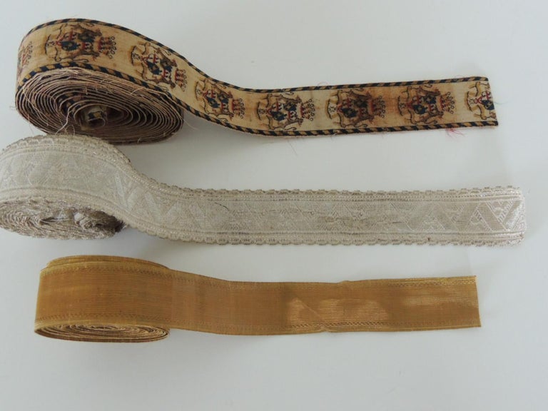 Set of (3) French antique textiles collection of decorative trims:
Passementerie:
Top: 19th century gold metallic threads military trim 9 yards, 1.5 inches thick.
Middle: 19th century silver metallic threads trim(2) pieces: 43
