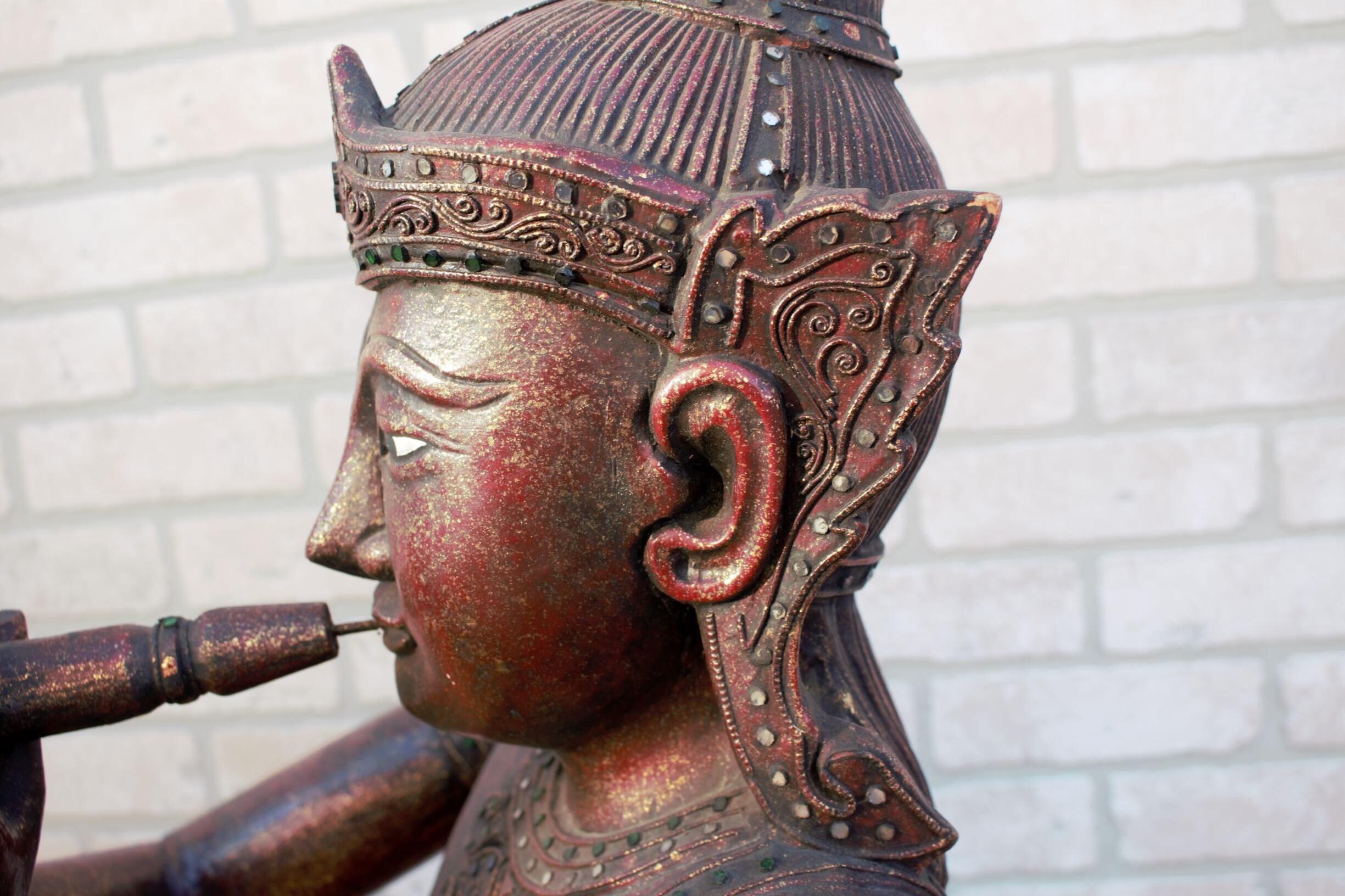 Antique Thai Carved Seated Buddha Playing a Flute In Good Condition For Sale In Chicago, IL