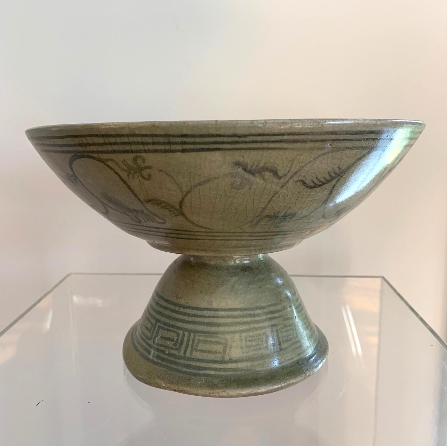 A celadon stemmed dish with underglaze deep blue decoration from Sukhothai (a former Kingdom in nowadays central Thailand) circa 14th-16th century. The pedestal dish was a typical ceramic output from Sawankhalok region, likely one of the kilns in