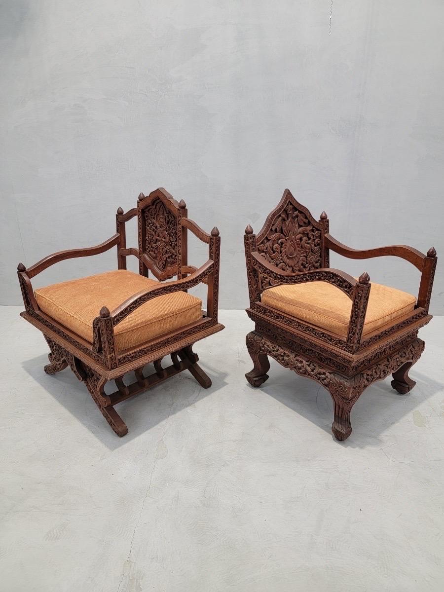 Antique Thai Howdah Hand-Carved Rosewood Ornate Saddle Chairs - Set of 2

These types of chairs are known as ‘Howdah’ chairs or sometimes ‘Elephant chairs.’ Unlike many of these types of chairs, the leg supports are not carved in the shape of