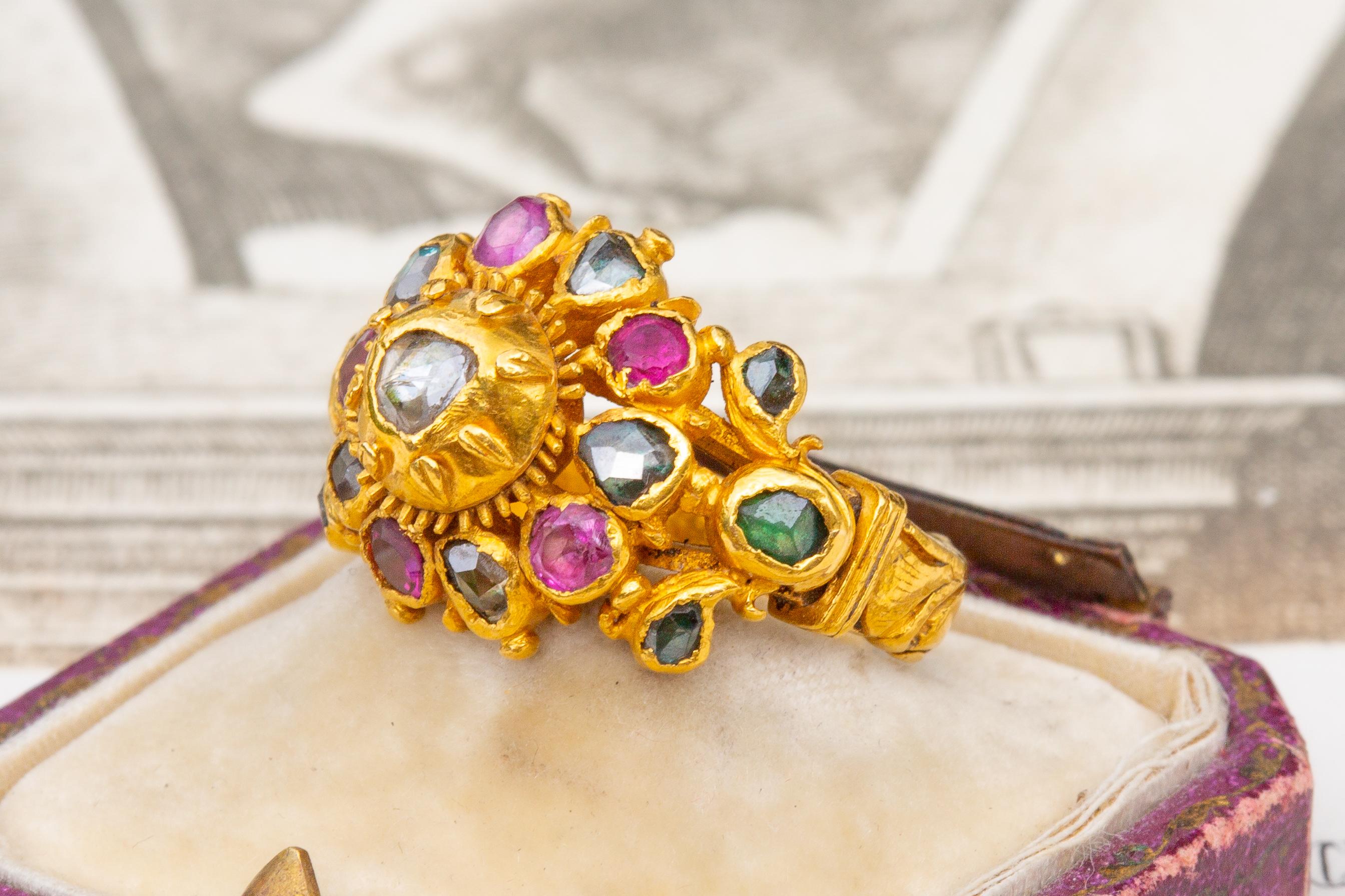 A rare late 19th century gem-set princely gold cluster ring made in Siam (Thailand).

This gorgeous and colourful gem-set cluster ring is intricately crafted in high-karat gold, by the goldsmiths of the Siam court in the 19th century. The centre