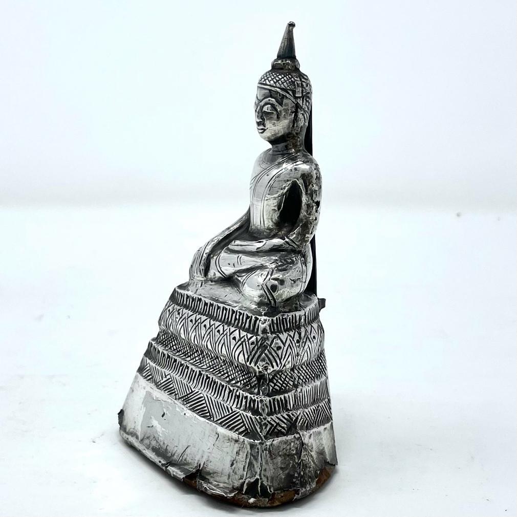Antique Thai Silver Buddha, rendered in incised and hammered sheet silver over wood & clay core. The Lord Buddha seated in padmasana with the soles of the feet upward and the hand gesture in bhumisparsa mudra (earth touching). At the top of the head