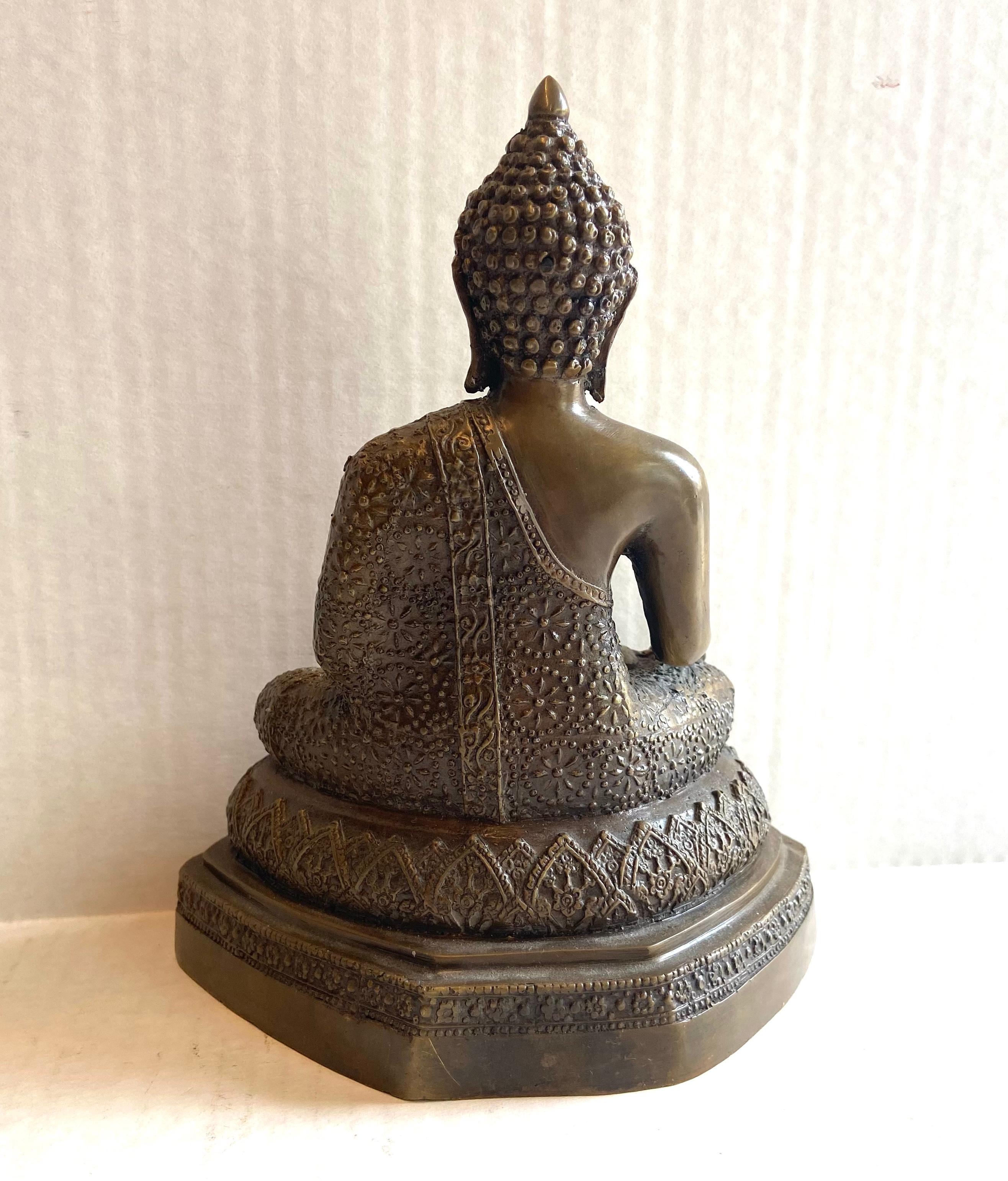The Thai Buddhas are always represented with different physical attributes, specified dress and specified poses. This particular one is the Buddha of Reasoning. The left arm is bent at the elbow and the wrist, with the palm facing outwards and the