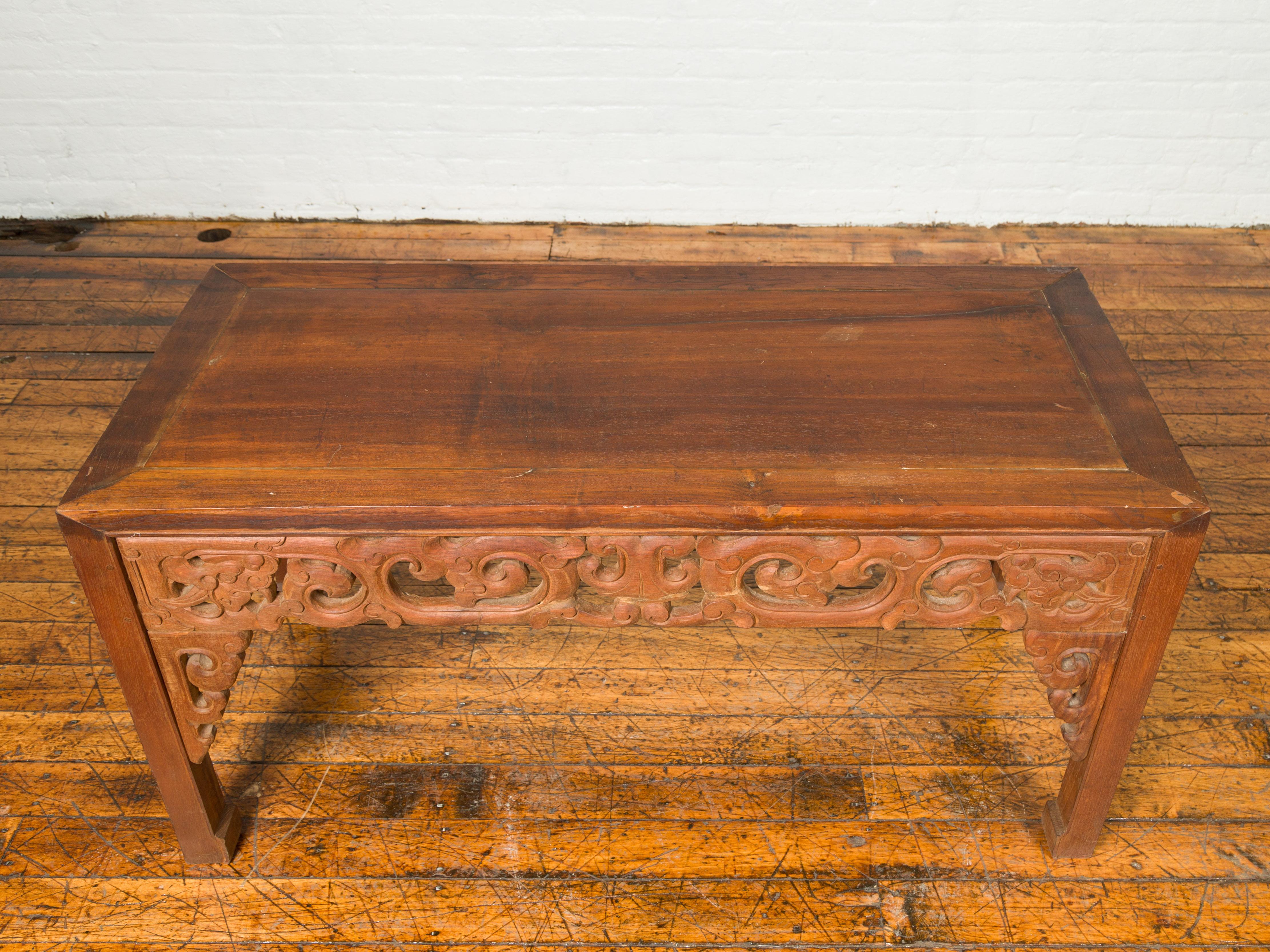 20th Century Antique Thai Teak Wood Side Table with Cloud Carved Apron and Horse Hoof Feet For Sale