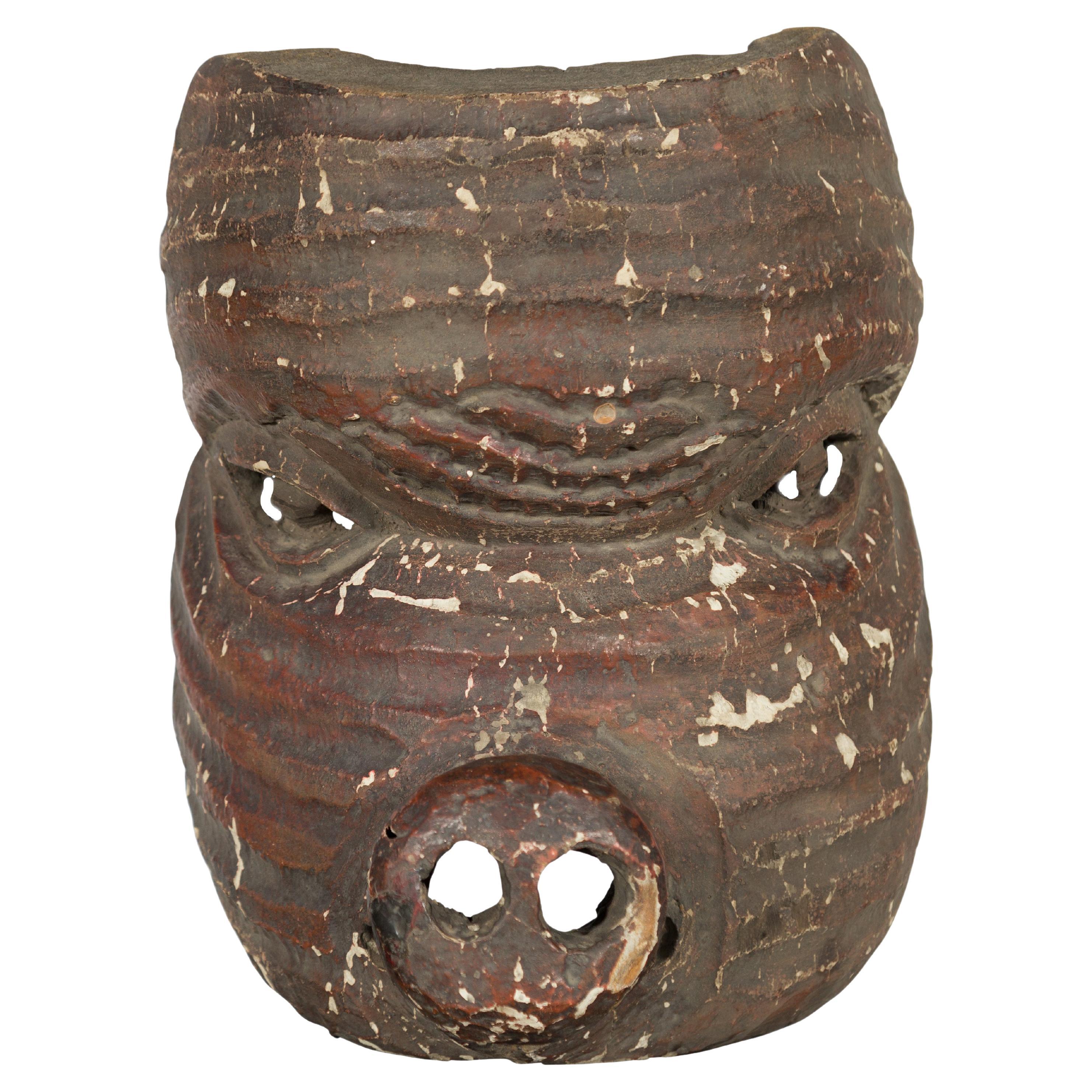 Antique Thai Tribal Carved Wooden Mask Depicting a Swine with Pierced Eyes For Sale