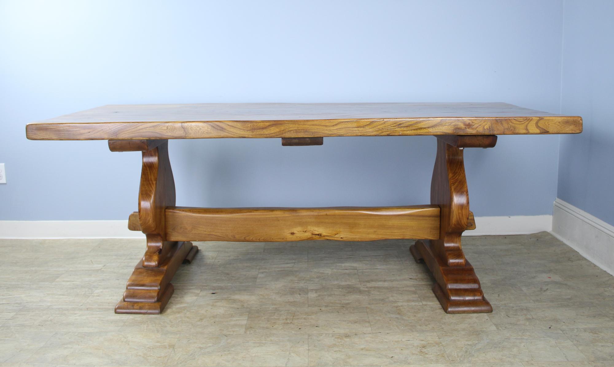 A handsome and beautifully crafted antique French elm refectory table with a 2.5 inch thick top and marvelous construction and design on the trestle base. With no apron to get in the way, this table can comfortably accommodate eight. Great color,