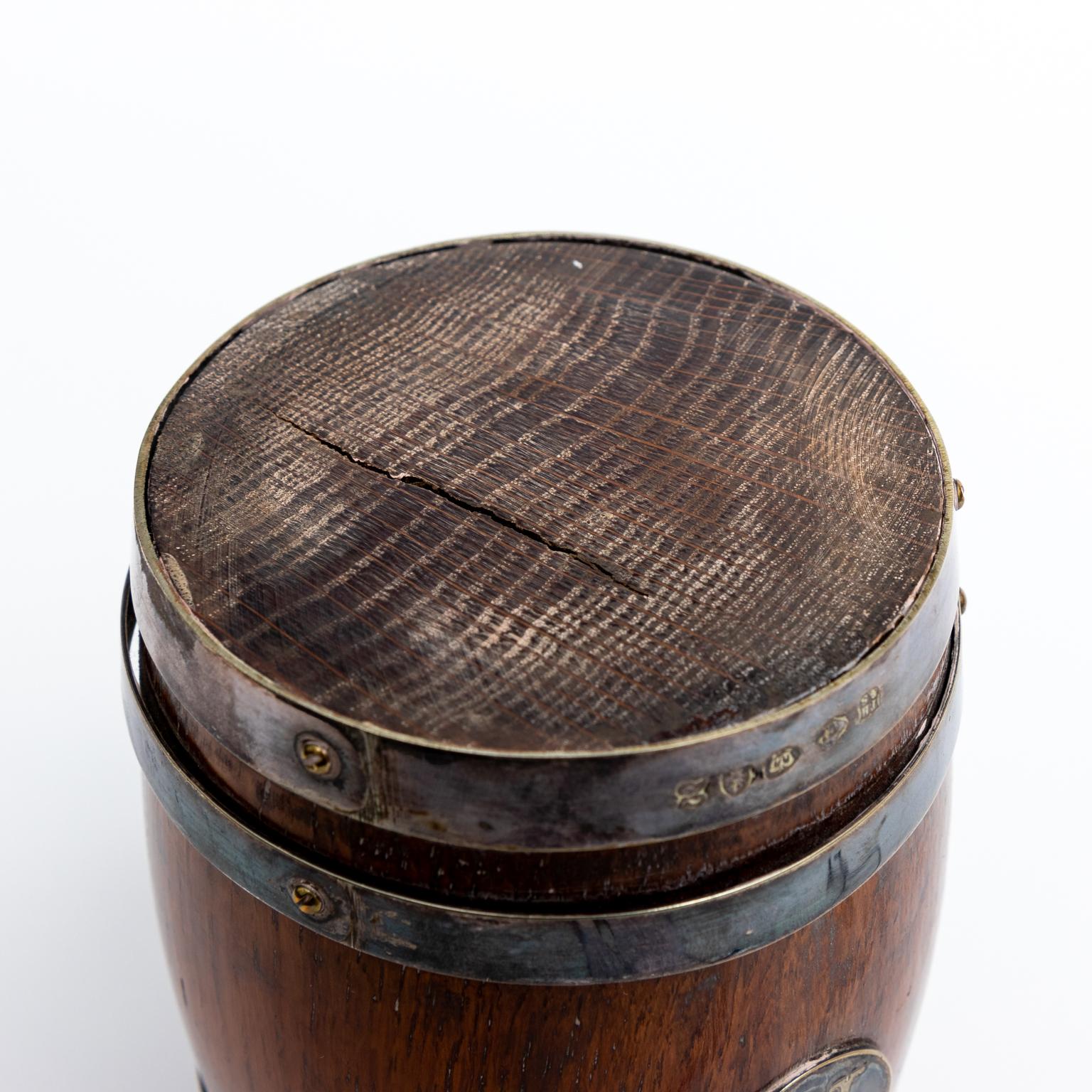 The Mark on this tankard dates back to pre 1896 Victorian Era. There are some cracks in the wood and the bottom ring moves a bit. This is normal wear for its age and use. It was named by a Birmingham Silversmith.
