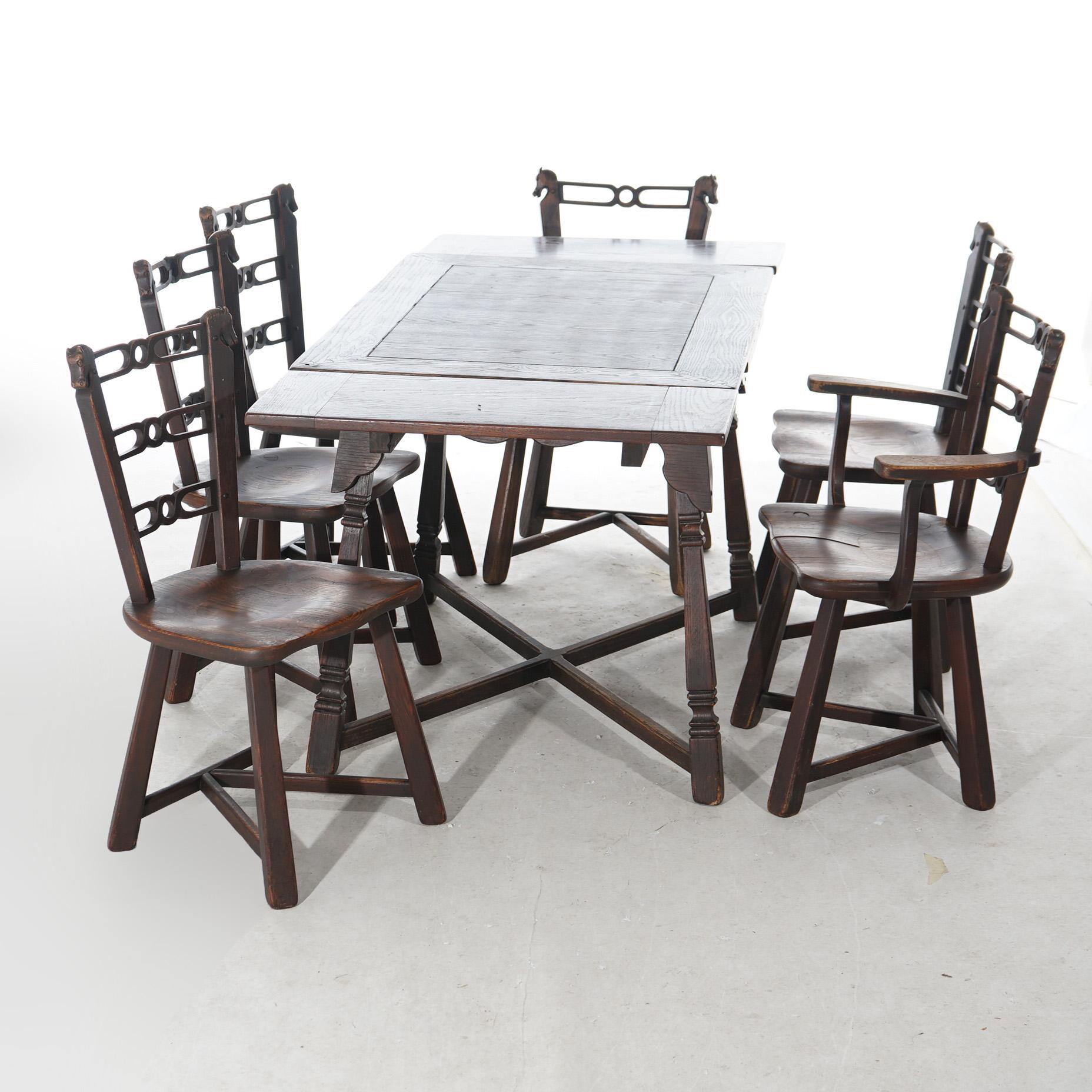An antique Thomas Molesworth Adirondack dining set offer oak construction with draw-top table and six ladder back chairs having flanking carved horse heads, c1930

Measures- Table 33.75''H x 48''W x 20.75''D;  Armchairs 33.75''H x 25''W x 20''D; 17