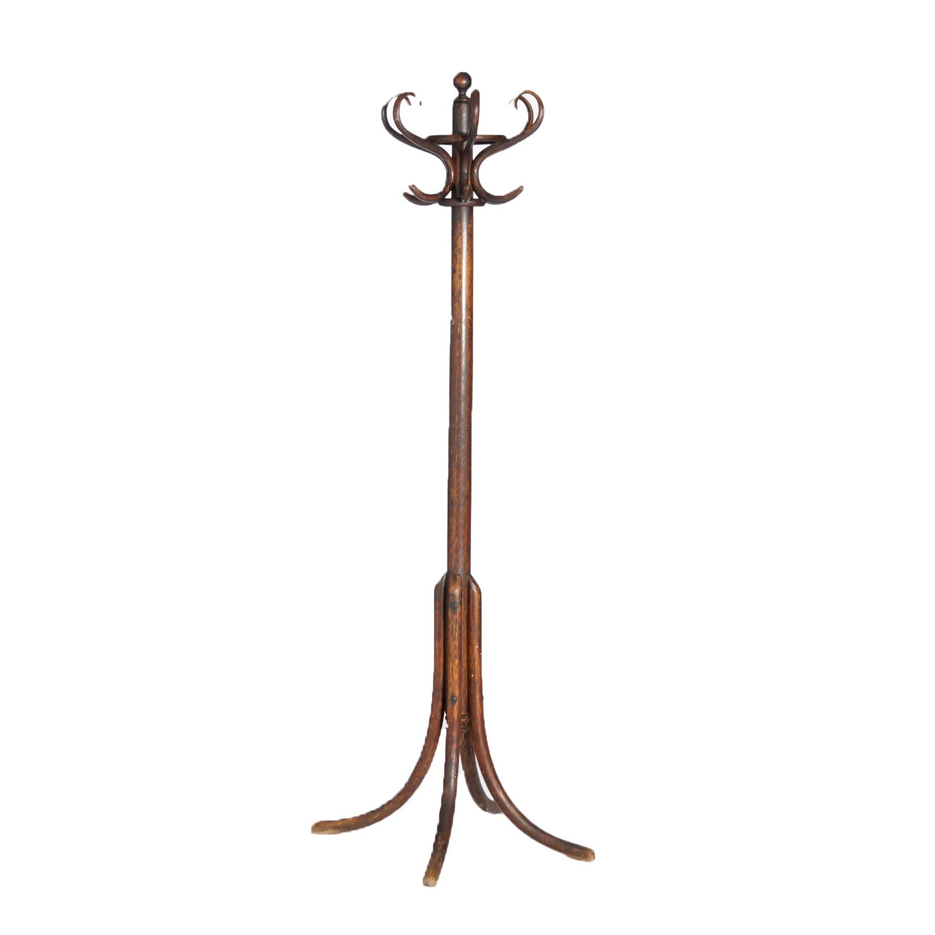 An antique Thonet hall tree offers bentwood oak construction with central column having scroll form hat hooks and raised on convex legs, c1920.

Measures- 67.5'' H x 25'' W x 25'' D.