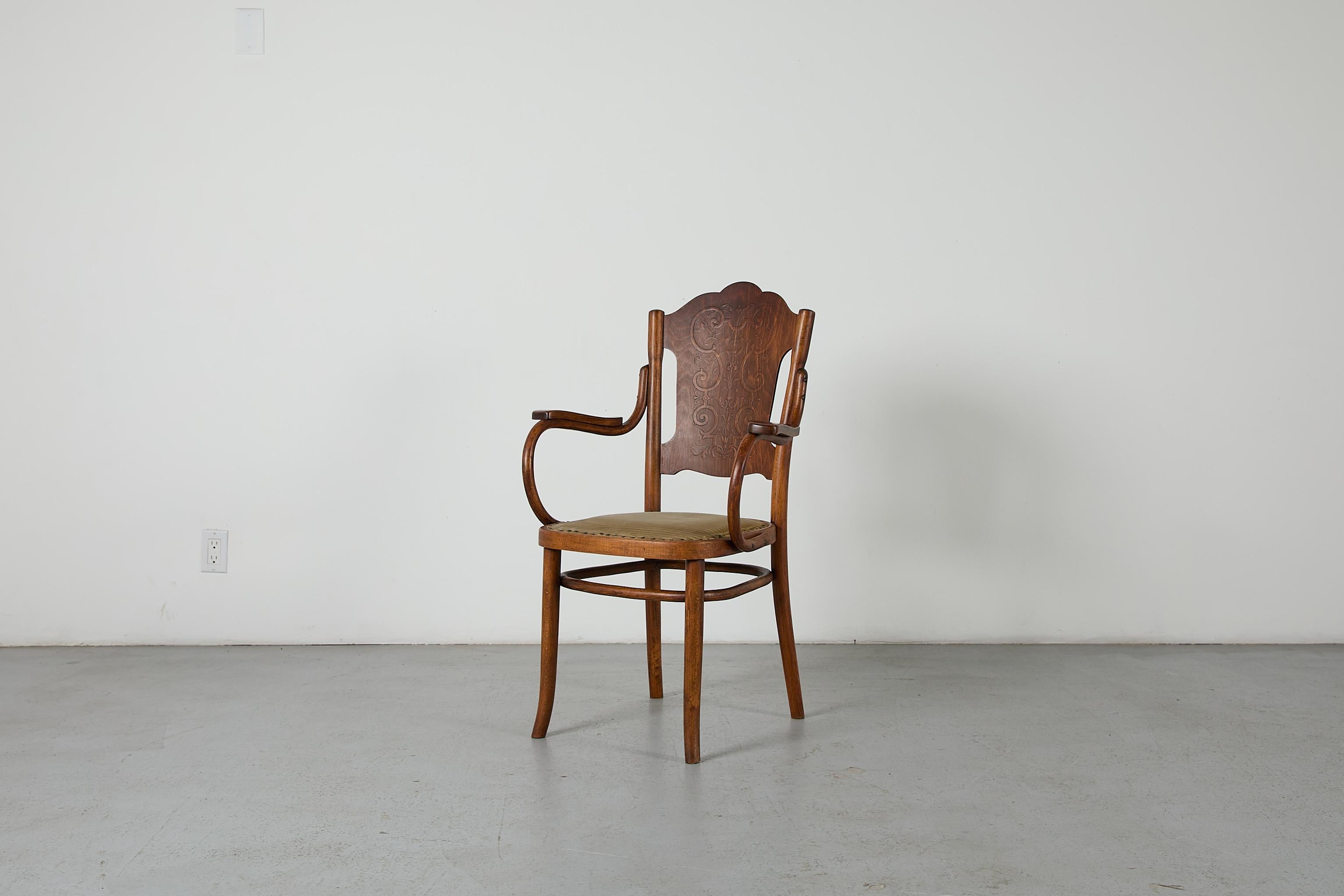 Rare, antique Gebrüder Thonet Bentwood Armchair Model No. 70. This genuine Thonet armchair was made in Vienna, Austria around 1904. It features a expertly crafted bentwood construction with an upholstered seat and handsomely carved backrest,