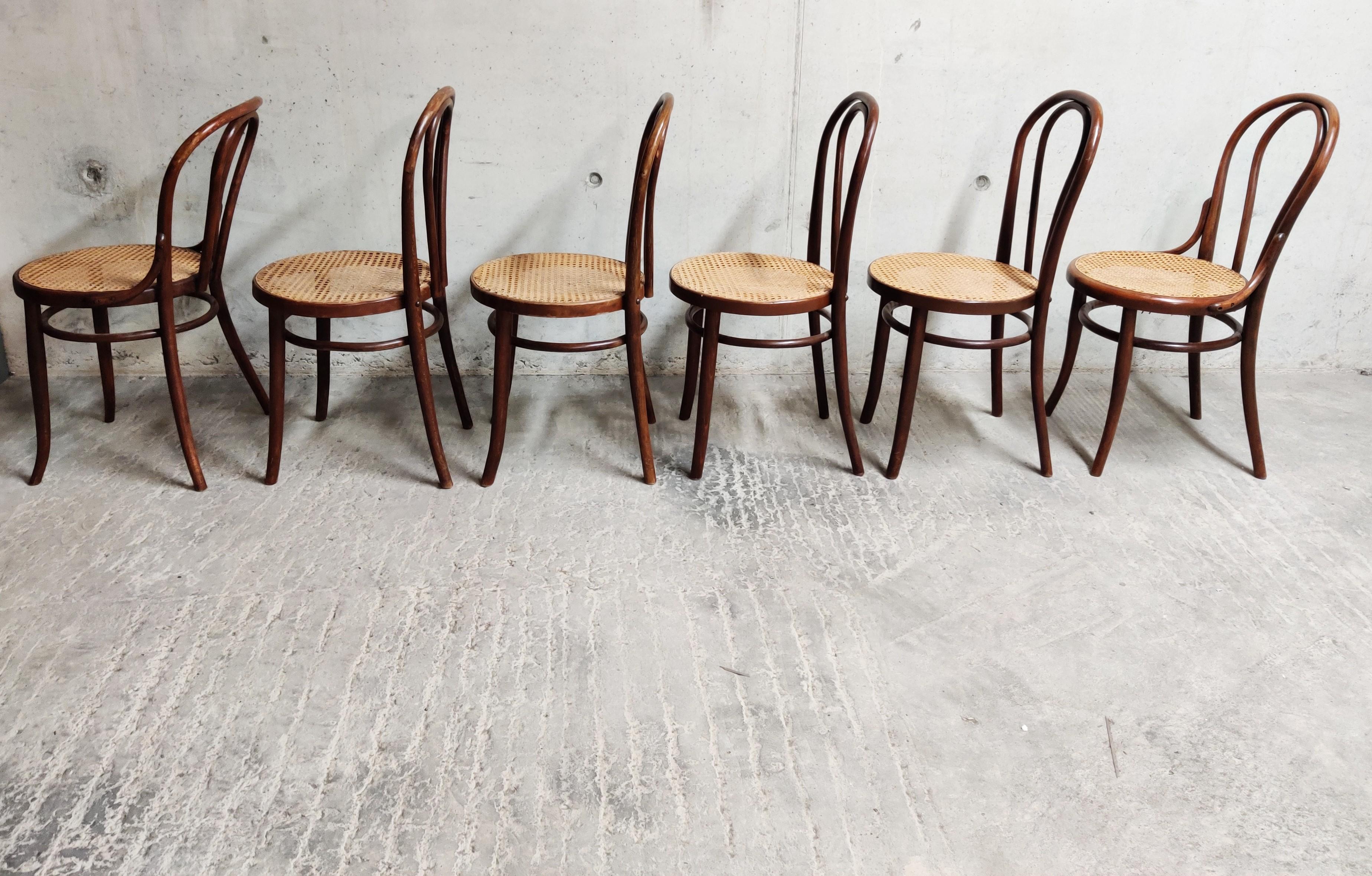 Set of 6 dark brown bent wooden dining chairs, like the thonet no. 18 and 18.

There are 4 chairs the same, and two slightly different (with an extra brace between backrest and seat), but they make a nice set.

The chairs are difficult to date,