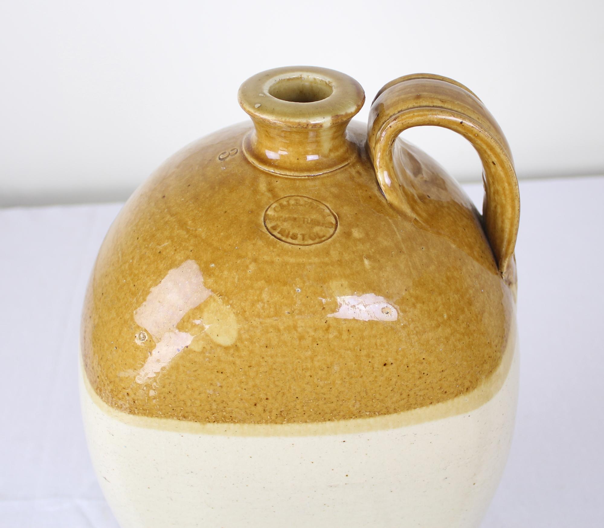 A large graceful brewer's jug from Bristol, England. Capacity of 3 gallons. Note the maker's thumbprint mark at the base of the handle in image #3.