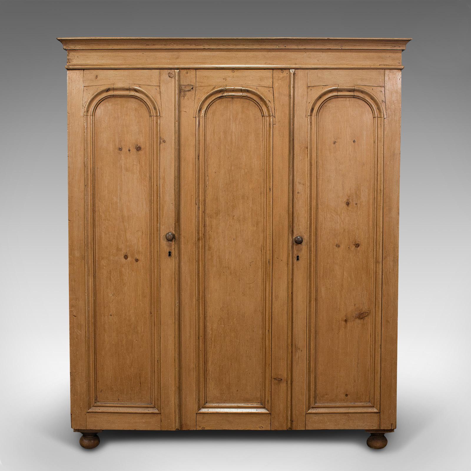 This is an antique three panel wardrobe. An English, pine cupboard or closet, dating to the late Victorian period, circa 1900.

Delightful Victorian wardrobe with nice colour
Displays a desirable aged patina
Select pine shows fine grain interest