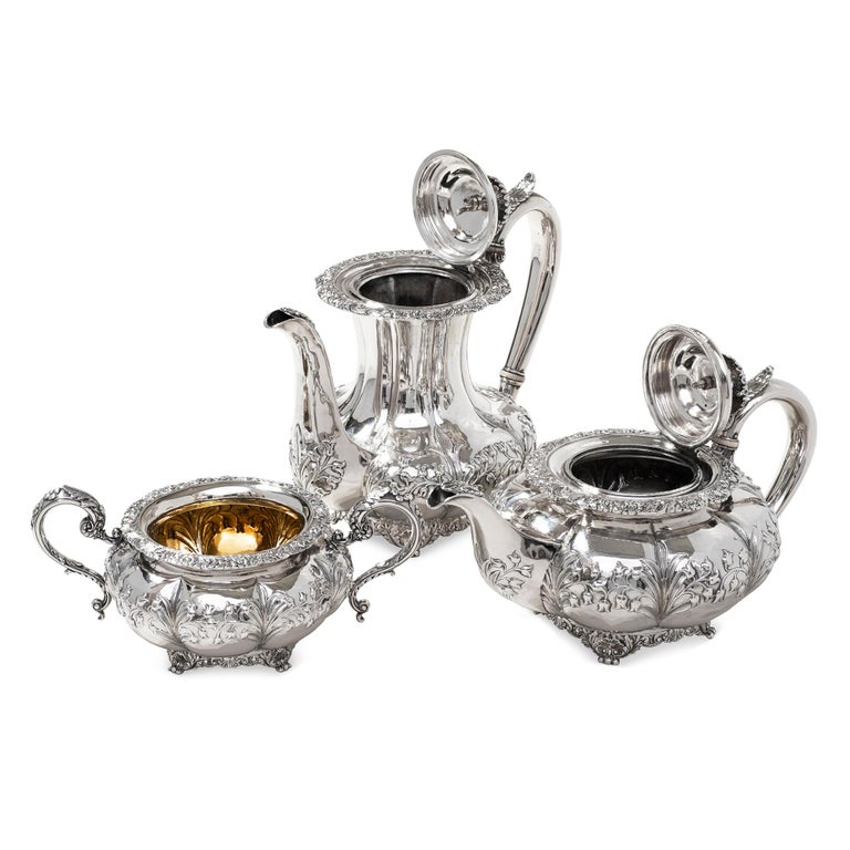 Antique three piece sterling silver tea and coffee set, comprising of a tea and coffee pot, sugar bowl, the bodies are decorated with floral repousse work, on to an applied scroll and shell base,the handles decorated with applied leaf forms, the