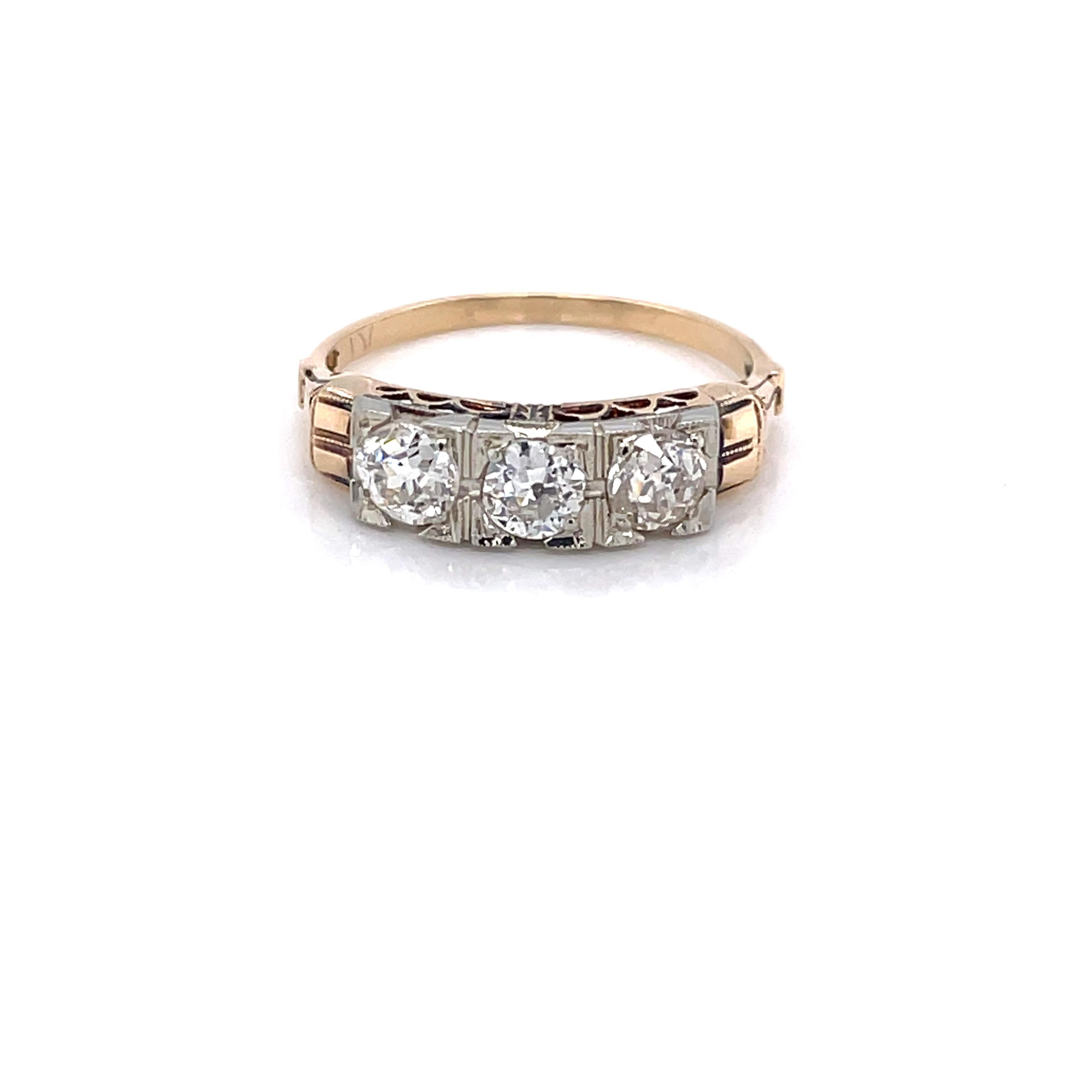 Three Miner's cut diamonds dress the front of the antique fourteen karat 14K ring. The ring's fancy gallery and gallery rail are notable features of this piece. The hand cut diamonds are G/I3 with a total carat weight of .30 carats. The stones do
