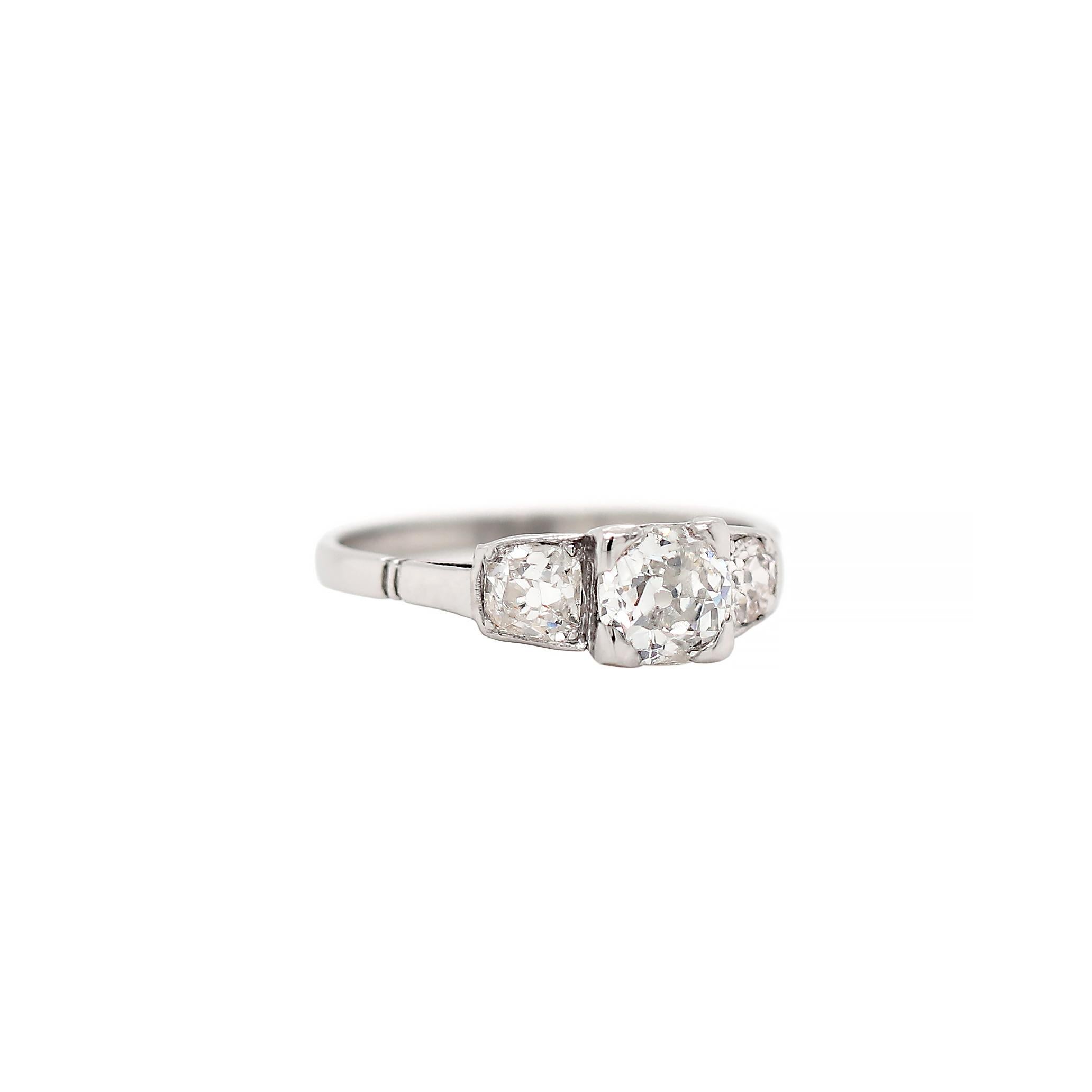This beautiful antique diamond three stone engagement ring features an old cut diamond centre stone weighing 0.75ct in a four claw open back setting. The diamond is mounted in-between two old cut diamonds with a combined approximate weight of 0.35ct