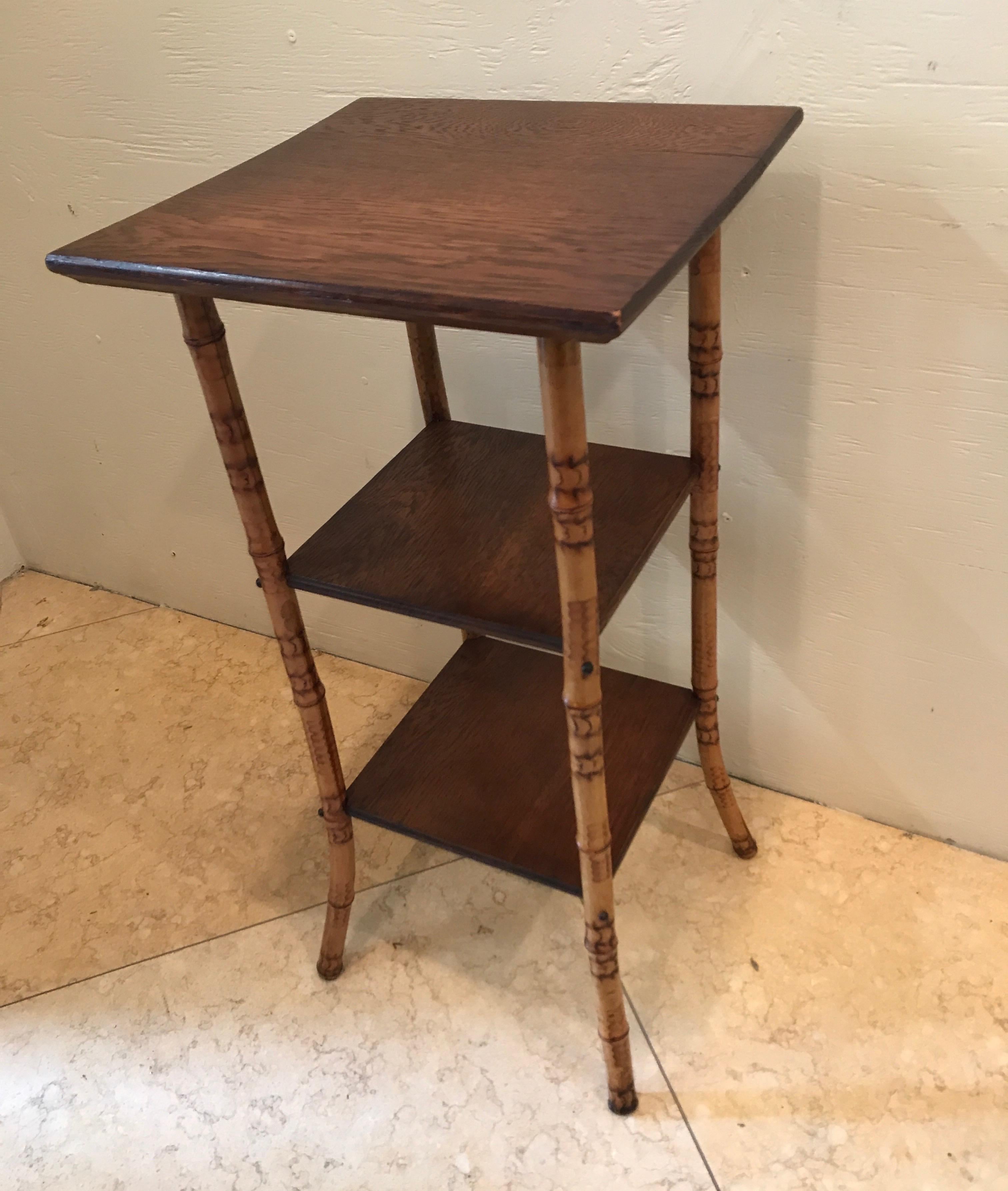 Antique bamboo stand with three wood shelves.