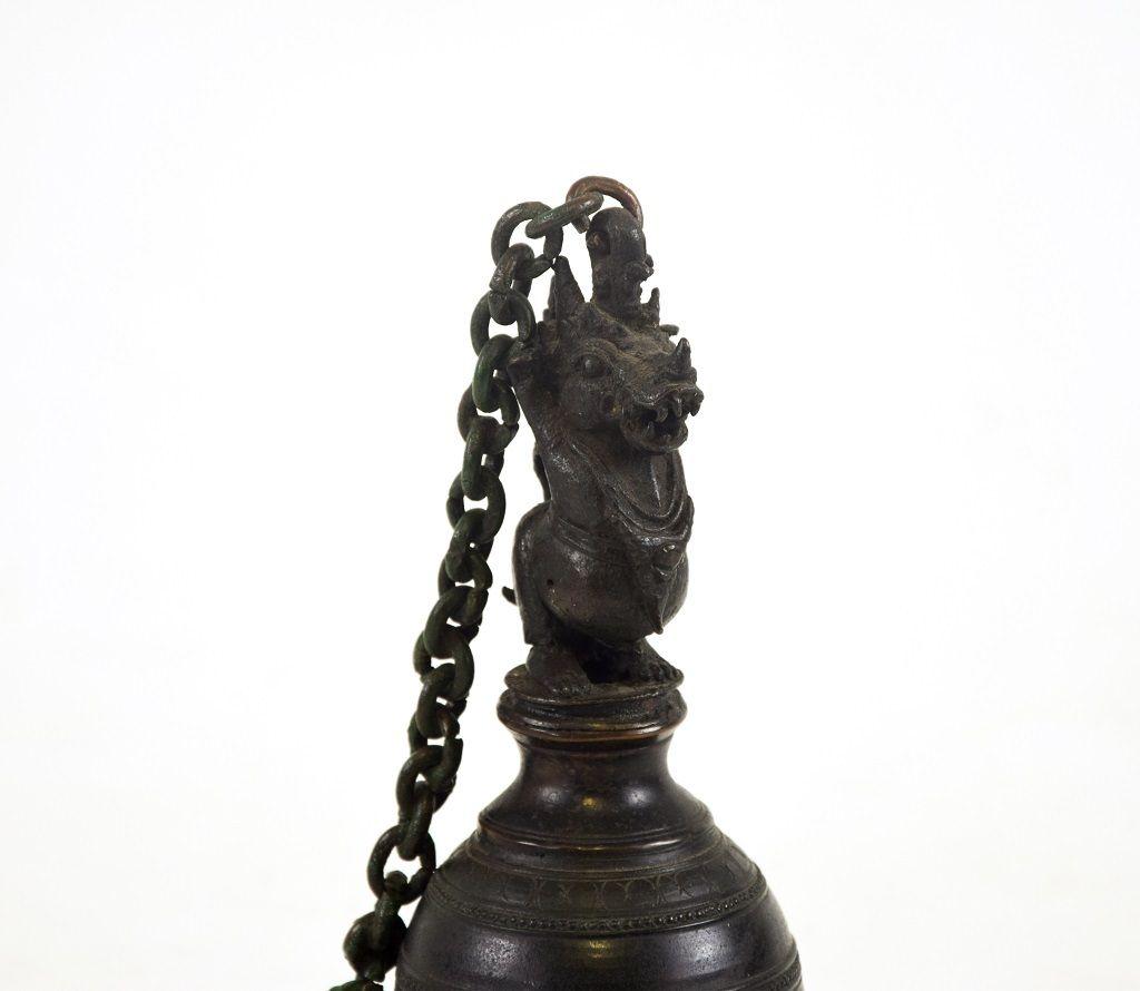 This Ritual bronze bell is an original bronze decorative object realized by Tibetan manufacture in the half of 19th century.

The bell has a dark bronze patina with geometric engraving decorations and a dragon head handle. 

This object is