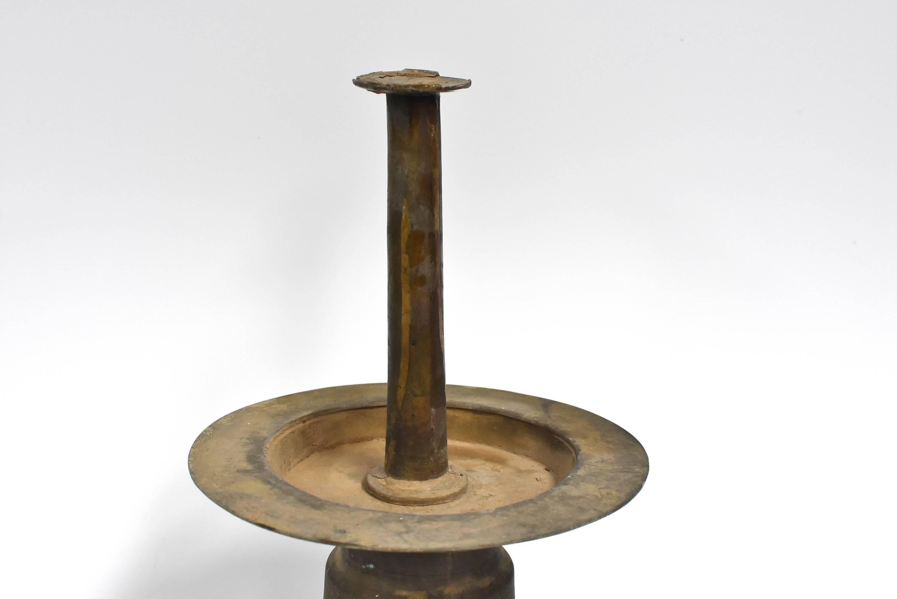 Beautiful bronze Tibetan oil lamp is all original. Featuring gradual rings on its bodice, forming a pattern that resembles water ripples, this design symbolizes the balanced harmony of water and fire. Such a lamp was used in the 19th century as an