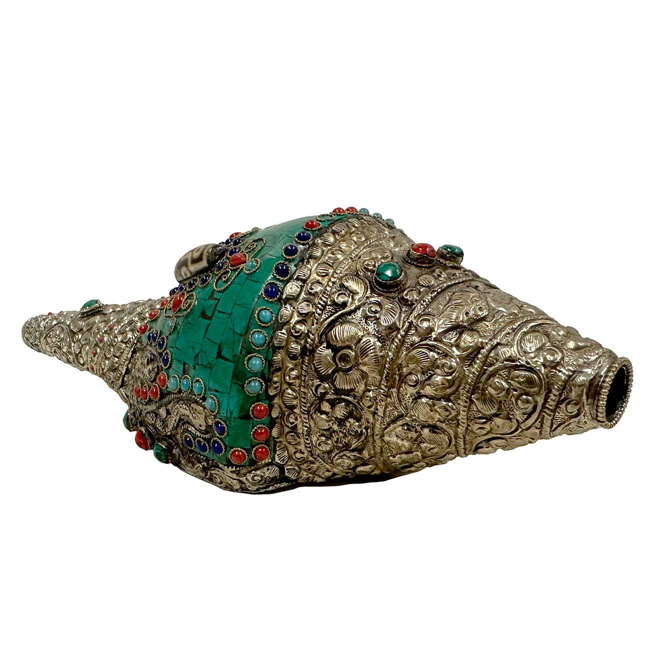 Cette coquille de conque naturelle bouddhiste tibétaine est fabriquée à la main à partir d'une coquille de conque 100 % naturelle, avec de l'argent tibétain, de la turquoise, du corail et des pierres. De plus, trois battements tibétains Dzi sont