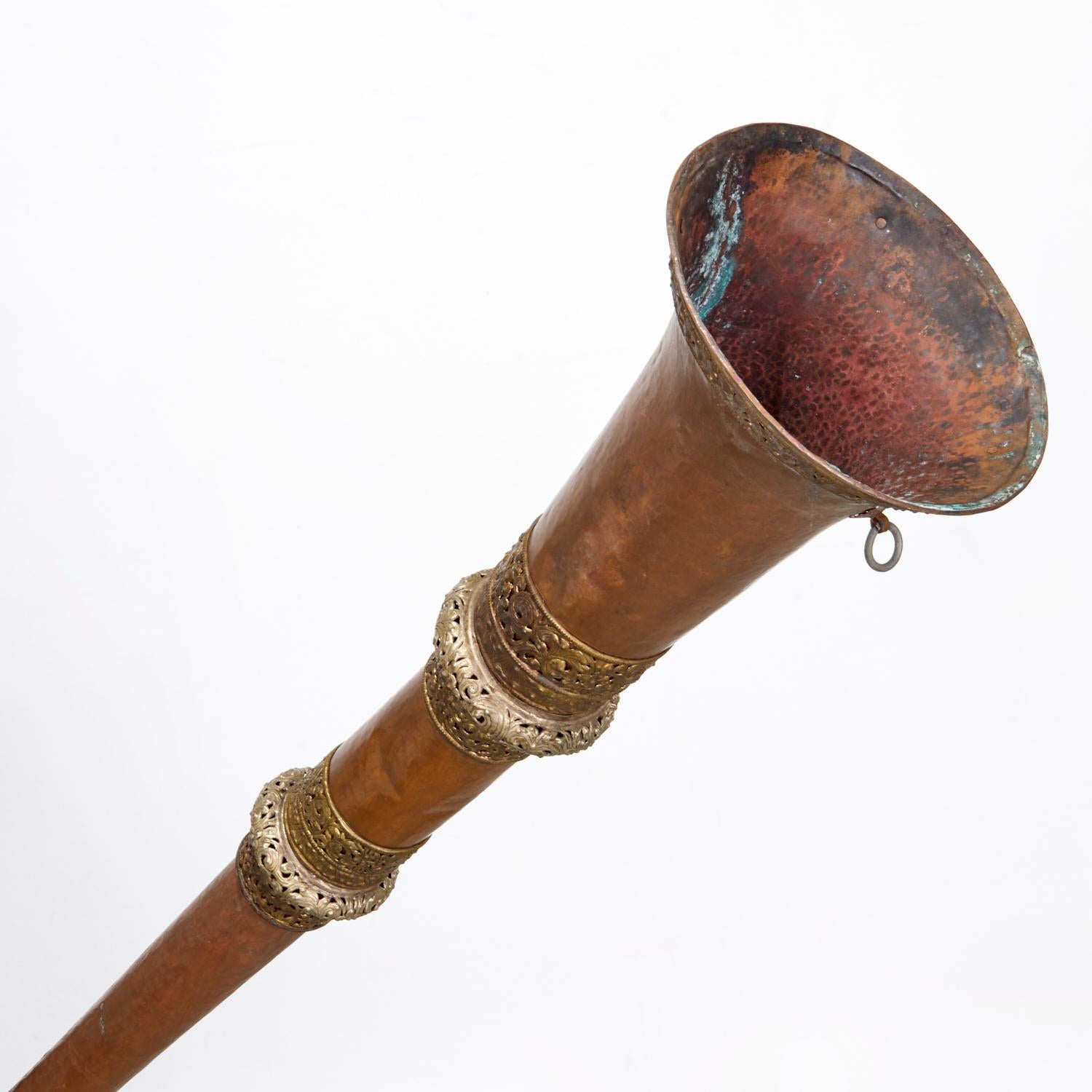 Late 19th/Early 20th c., Tibet. A hand hammered copper moniastic instrument with pierced silvered brass cuffs and telescoping length.

This item came from Barbara J. Walters NYC apartment and was one of the exceptional, diverse, and fascinating