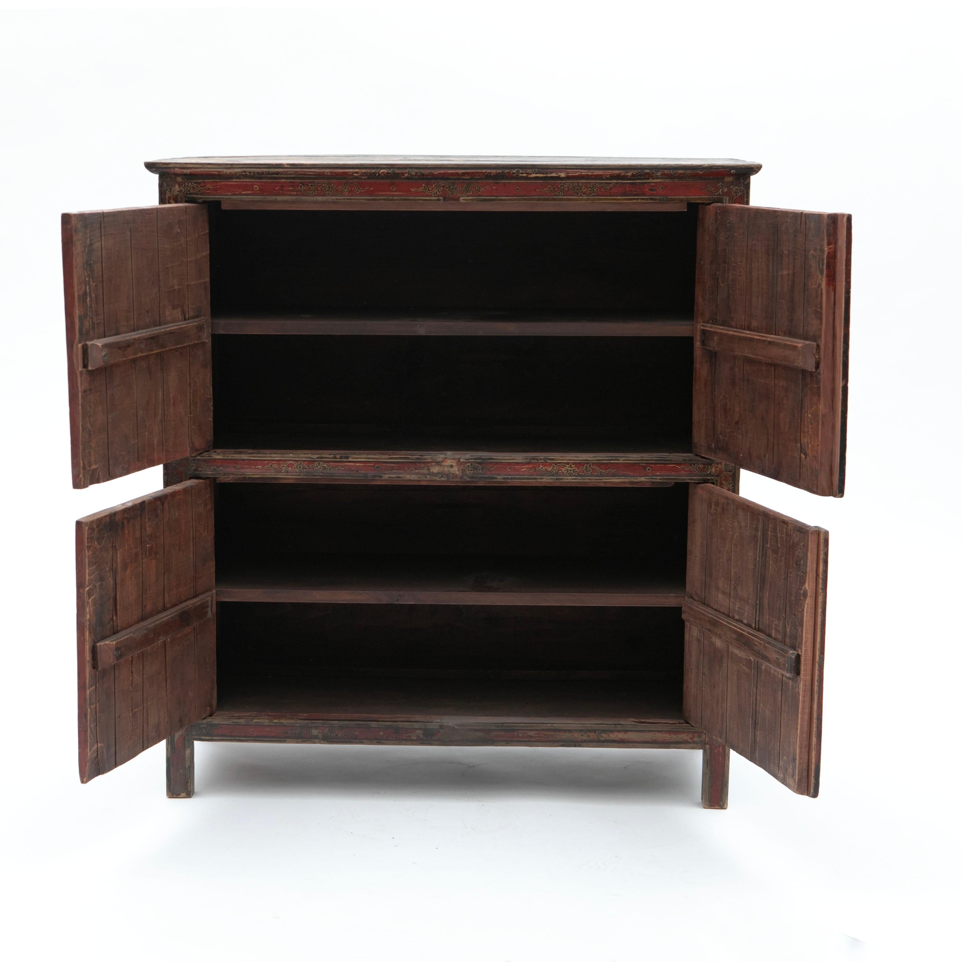 Beautifully Decorated Tibetan Cabinet in Well-Preserved Original Condition
This Tibetan cabinet features two pairs of doors, richly adorned with traditional motifs, including intricate dragon designs. Behind the doors, shelves provide ample storage
